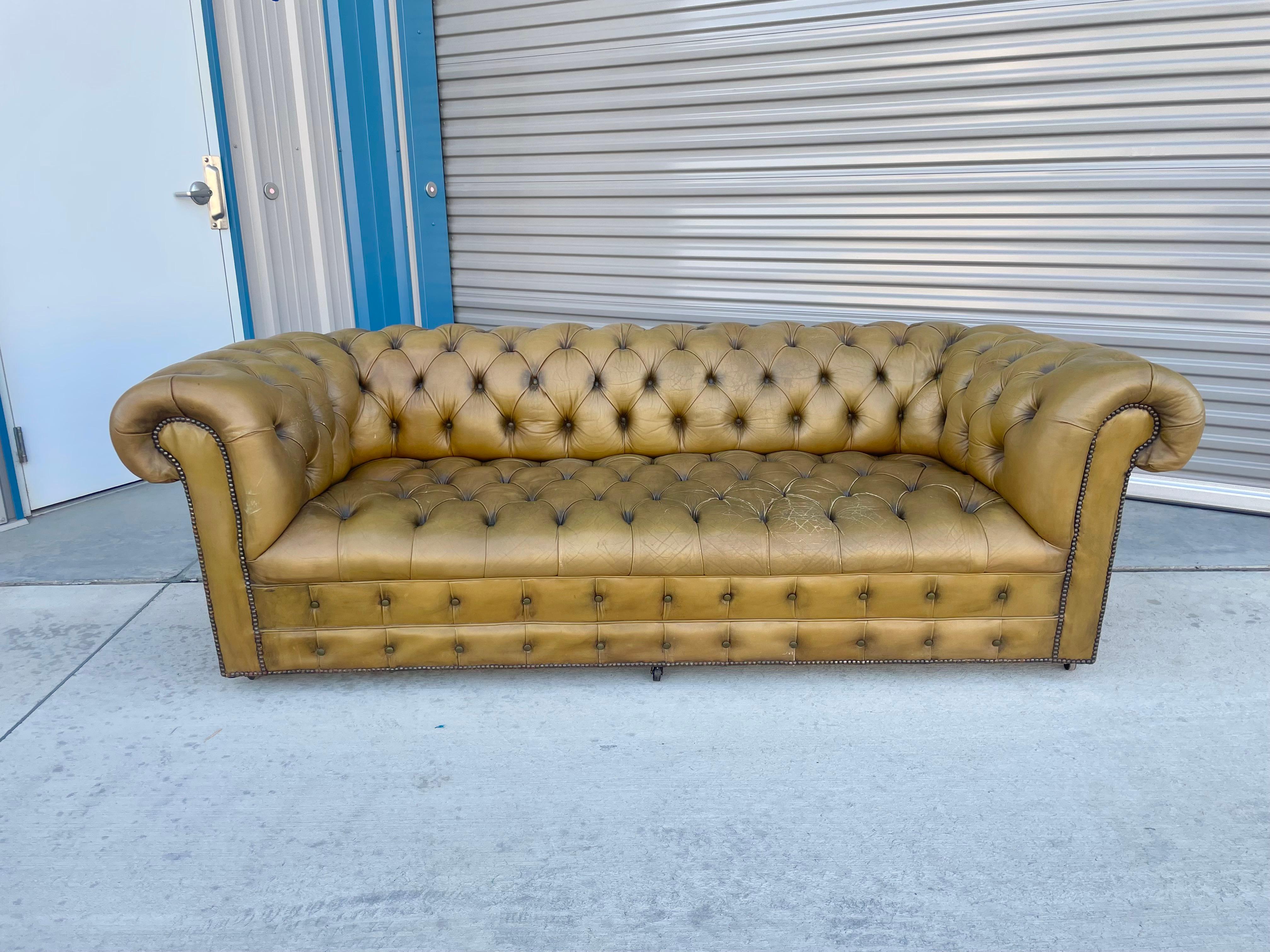 Vintage leather Chesterfield sofa designed and manufactured in the United States circa 1970s. This stunning sofa features a leather tufted upholstery that gives it a classic and timeless look. I absolutely love its unique design and how comfortable