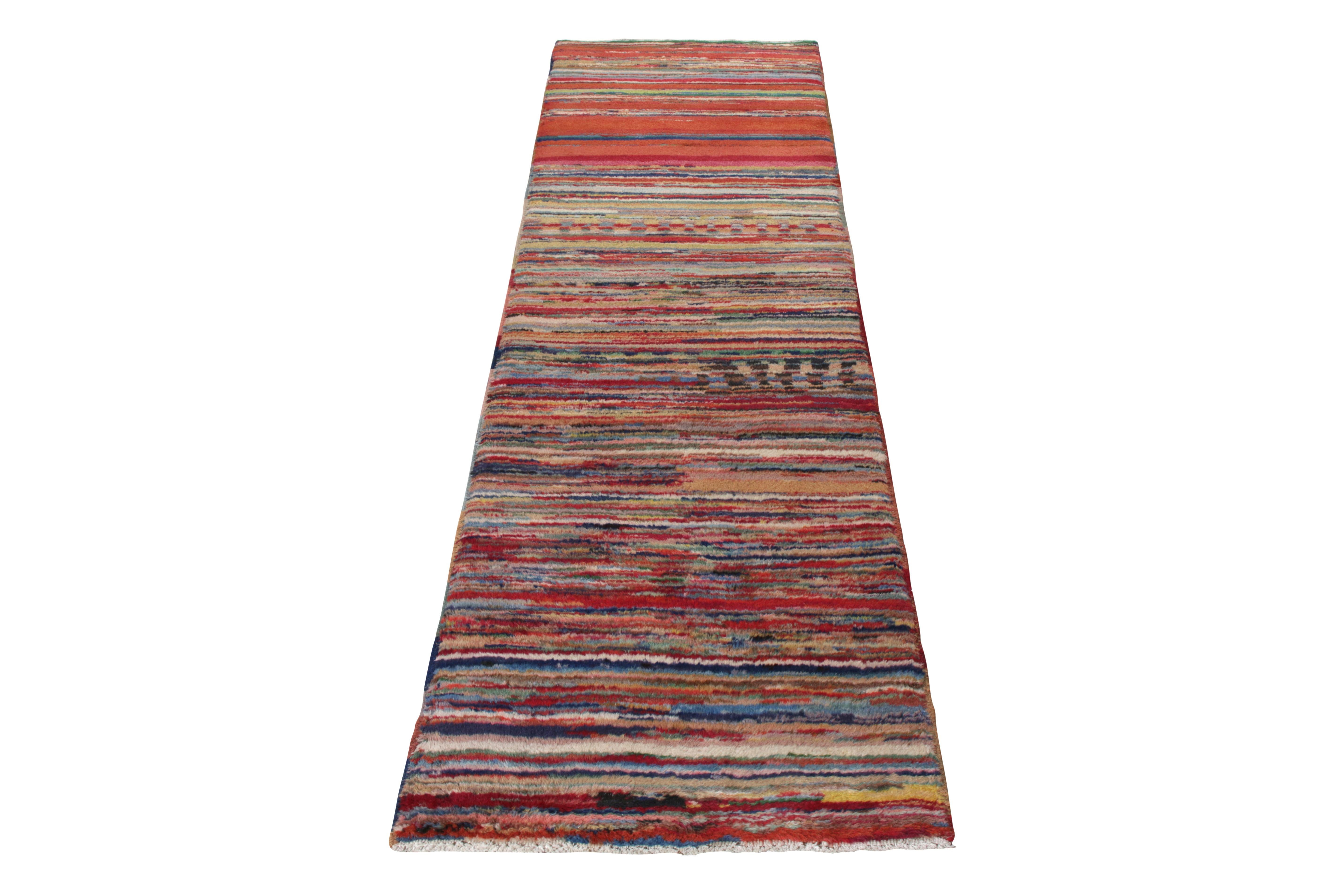 Celebrating the mid-century style of the 1960s, Rug & Kilim presents this 2x8 Turkish vintage runner crafted by Zeki Muren from their commemorative Mid-Century Pasha Collection. Hand-knotted in wool, this piece enjoys a montage of striations and