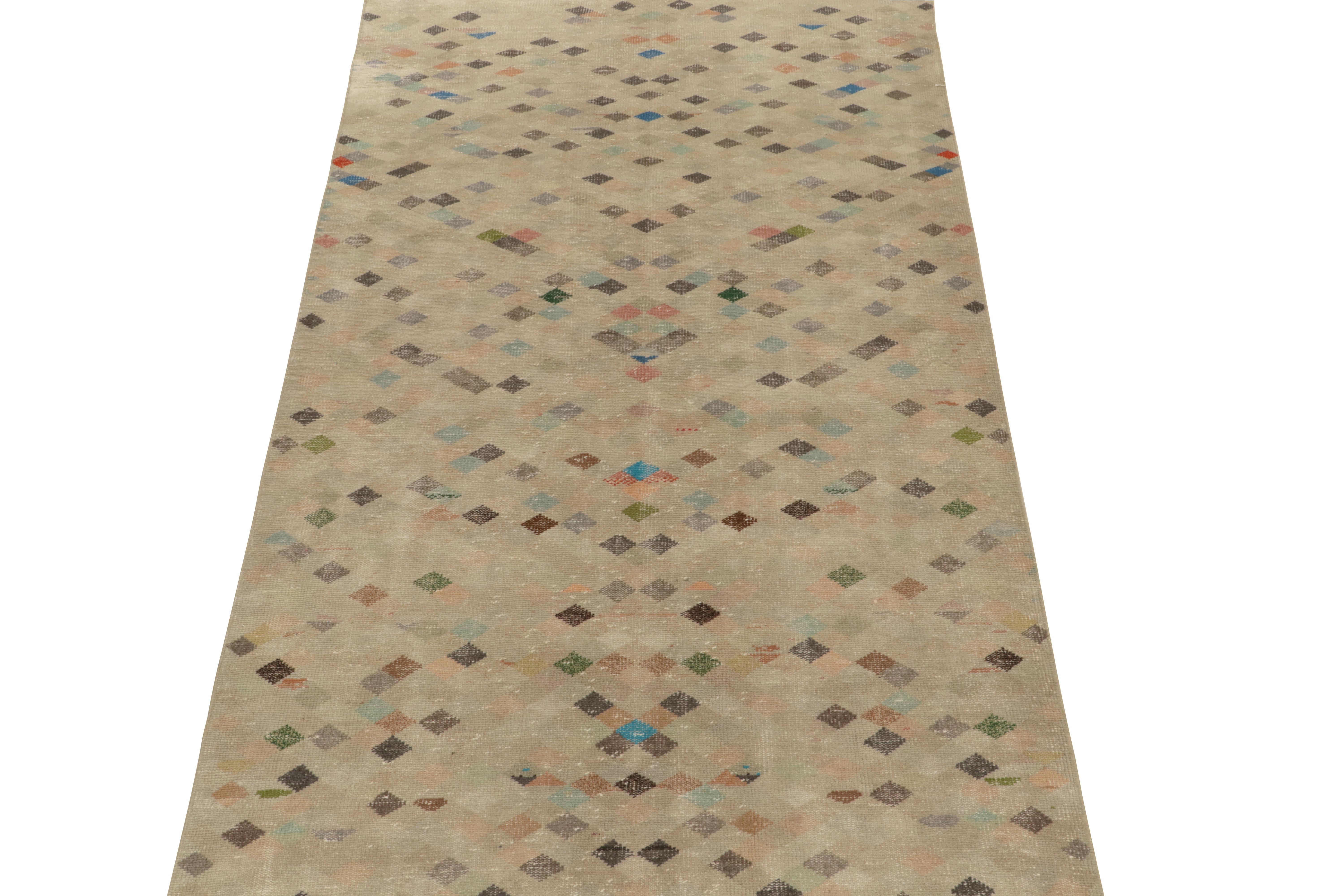 Hand-knotted in wool, a 5x9 vintage rug from a soulful Turkish atelier, entering Rug & Kilim’s commemorative Mid-Century Pasha Collection. 

This dedicated piece enjoys a sublime geometric pattern alternating with greige, blue, brown and black