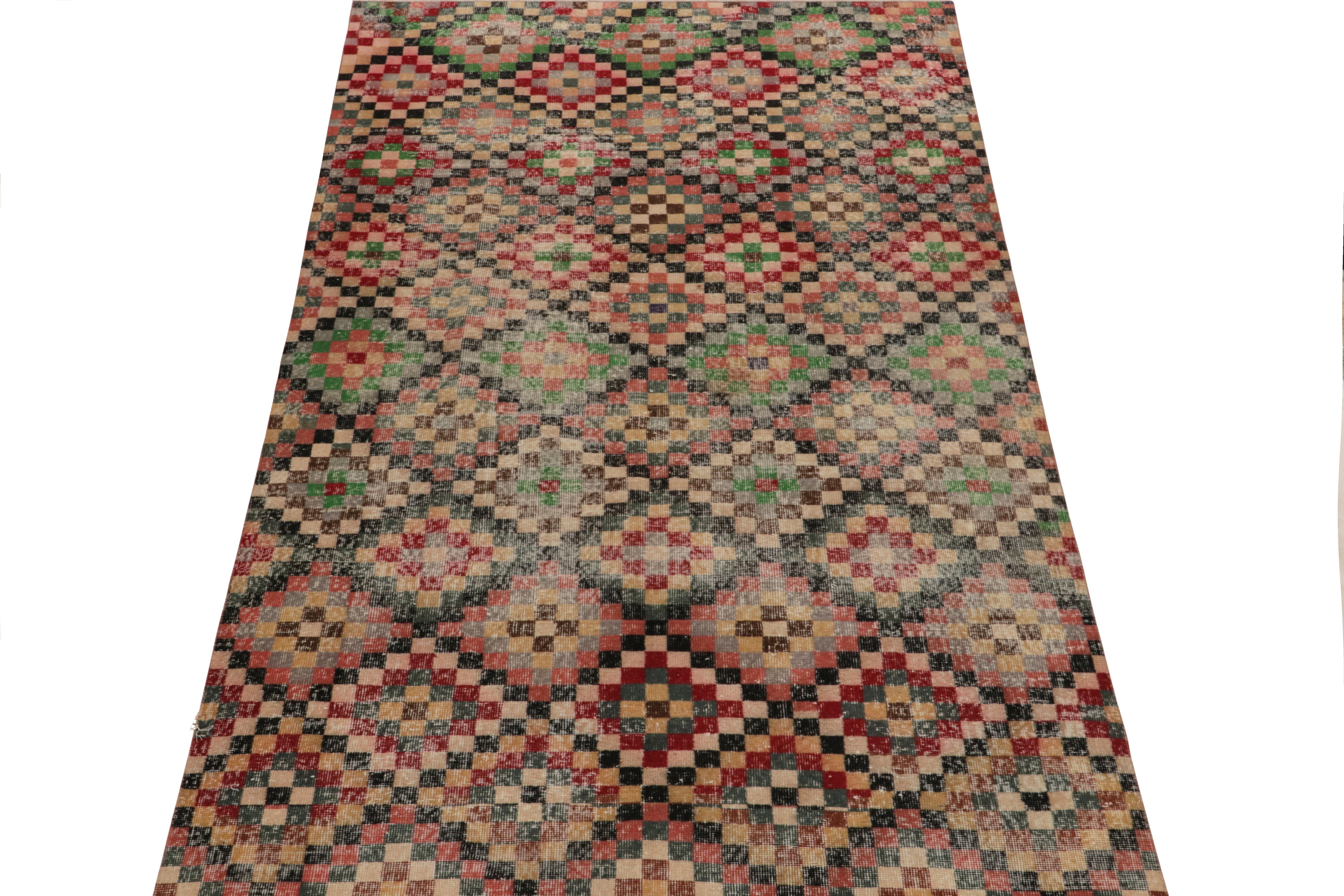 Hand-knotted in wool, a 6x10 vintage rug from a revered Turkish atelier, entering Rug & Kilim’s commemorative mid-century Pasha Collection. This dedicated piece enjoys a dextrous geometric pattern in variegated tones of red, green beige & black—a