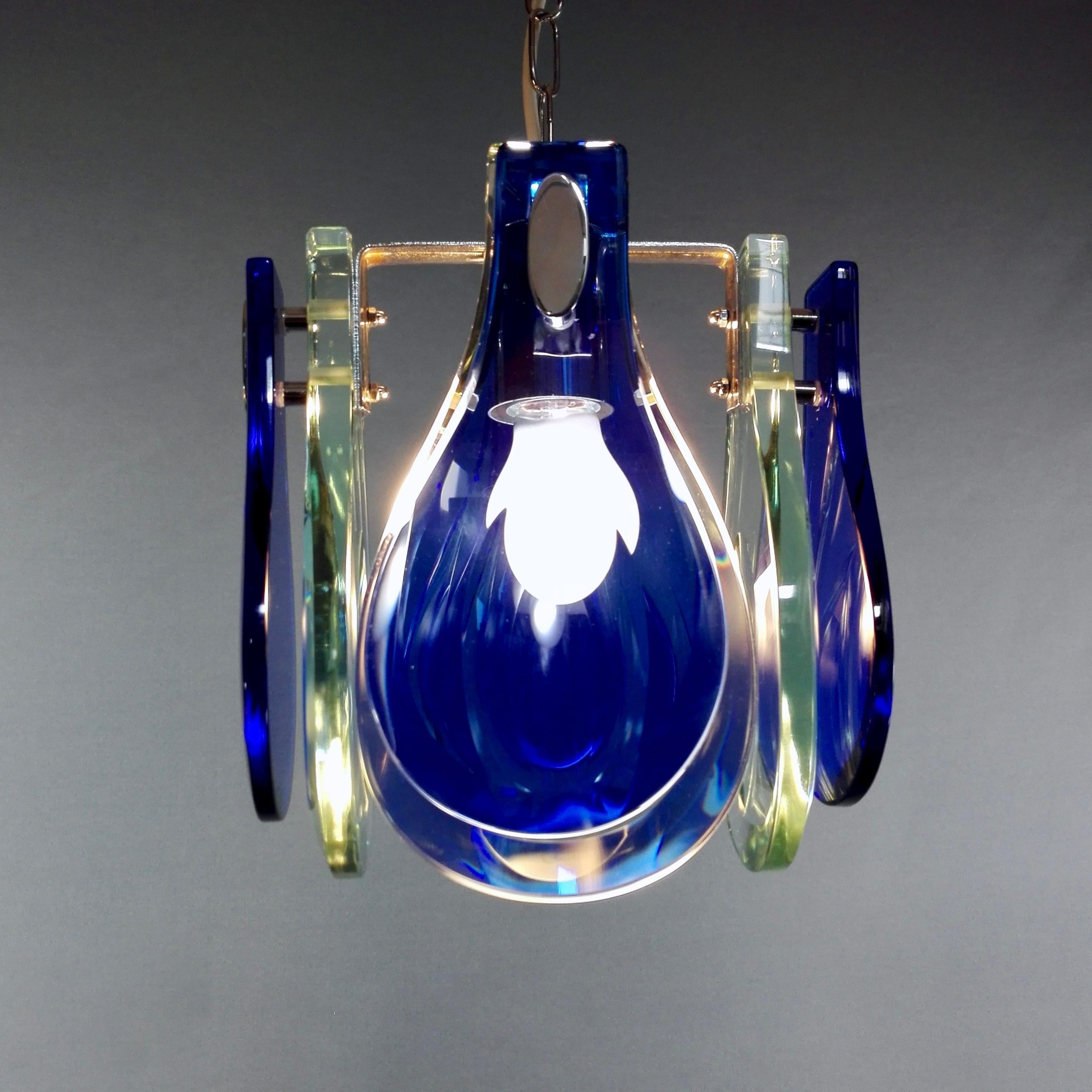Beautiful vintage one-light 1960s pendant lamp with ultramarine blue / teal glass and chrome, in very good condition. 
This colour combination is truly rare and impressive. 
There is no trademark on the lamp, however the design of the structure and