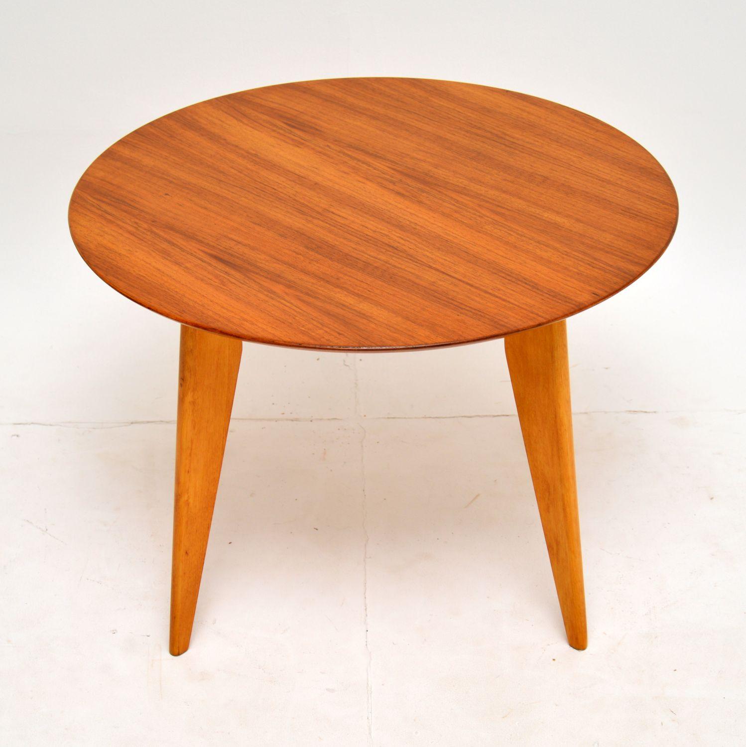 A smart and stylish vintage coffee table or side table in walnut. This was made by H. Shaw of London, it dates from the 1960’s.

This has a beautifully made circular top, and sits on fine splayed solid wood legs. The makers label can be seen below