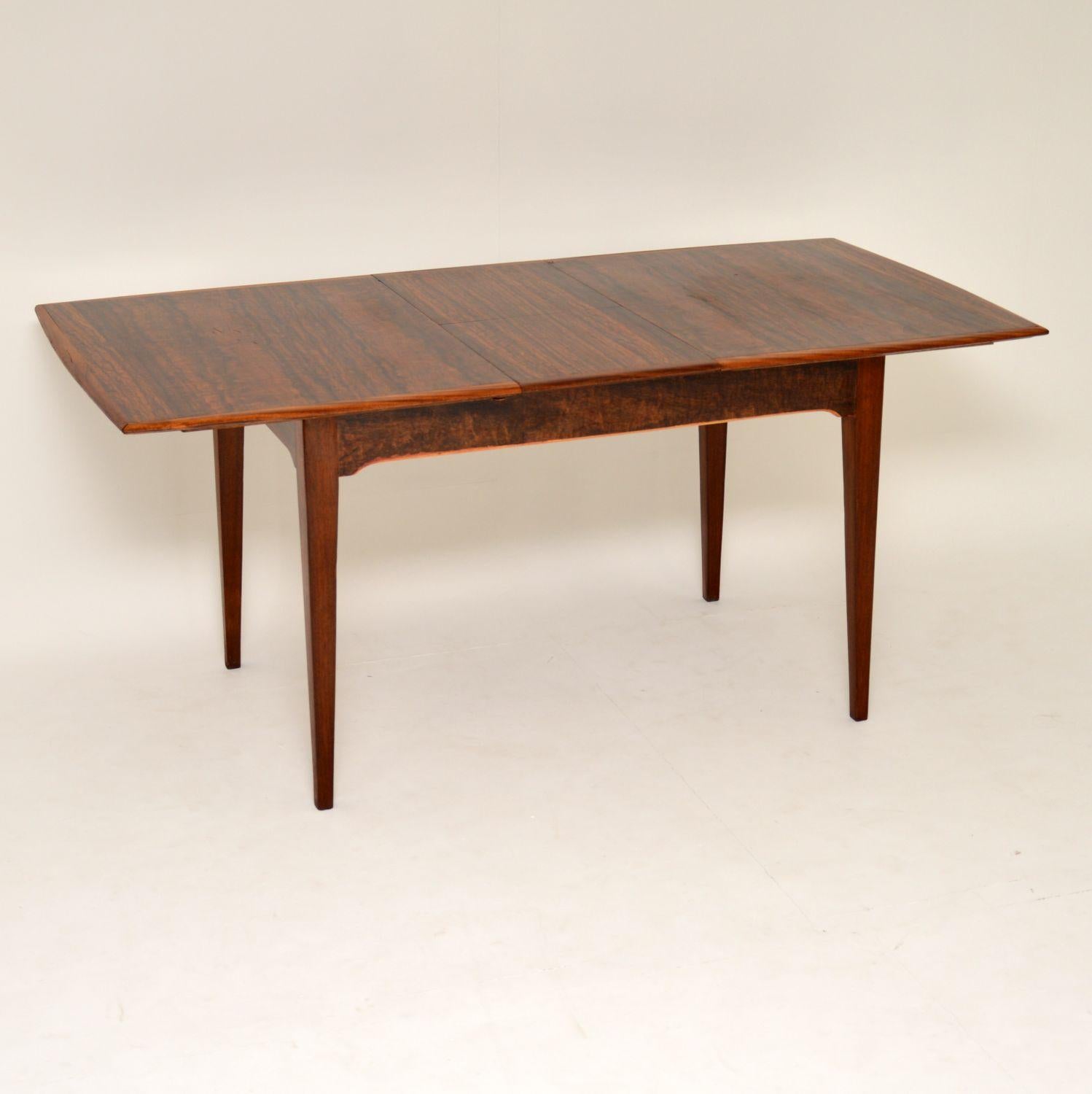 A smart and stylish vintage dining table in walnut, this was made by Alfred Cox in the 1960s. It is in nice condition for its age, it looks like it was restored by the previous owner, so has a nice rich and even colour, with beautiful grain