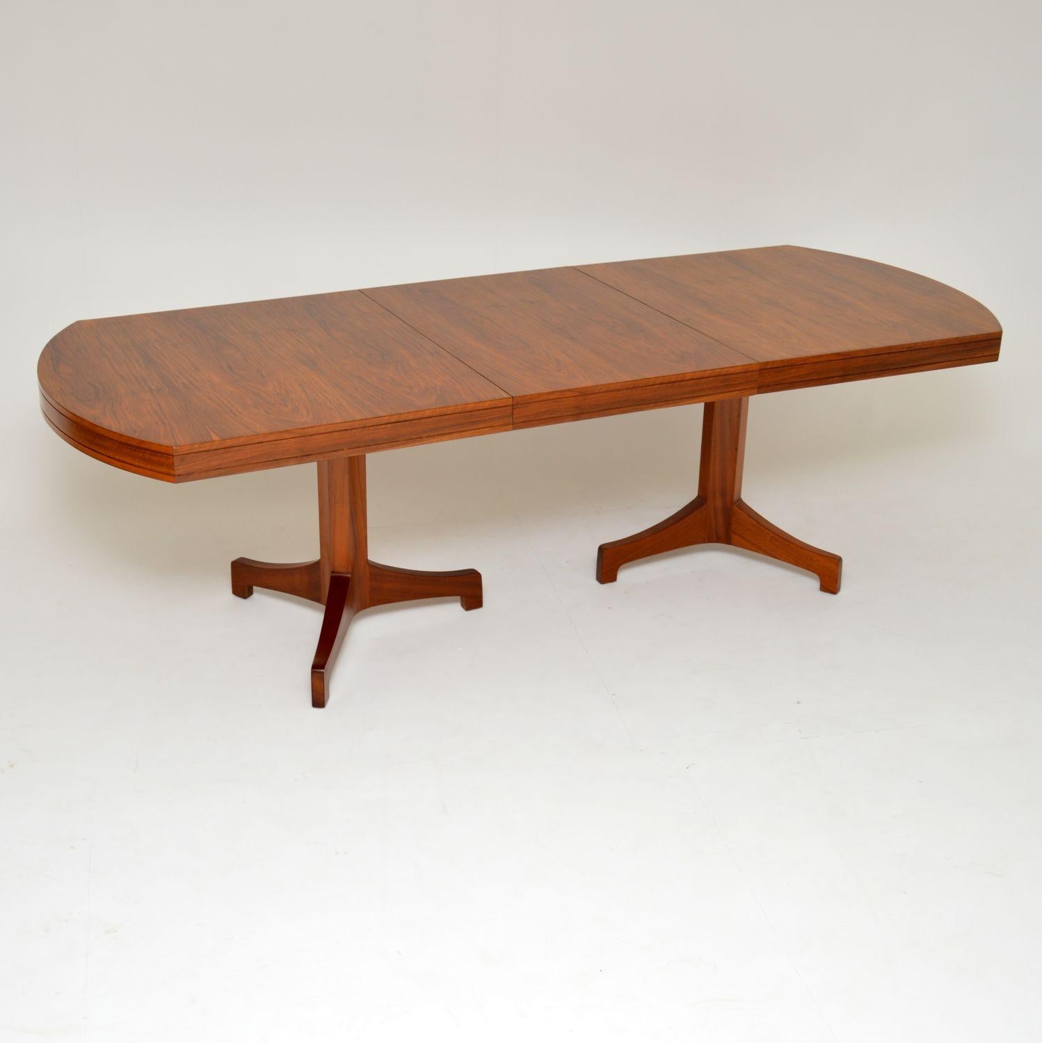 A magnificent and extremely rare vintage extending dining table in walnut, this dates from the 1960s. The previous owner who had it from new was adamant that this was a Robert Heritage design for Archie Shine. This may or may not be the case, the