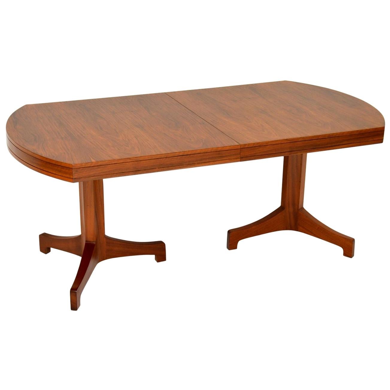 A magnificent and extremely rare vintage extending dining table in Walnut, this dates from the 1960s. The previous owner who had it from new was adamant that this was a Robert Heritage design for Archie Shine. This may or may not be the case, the