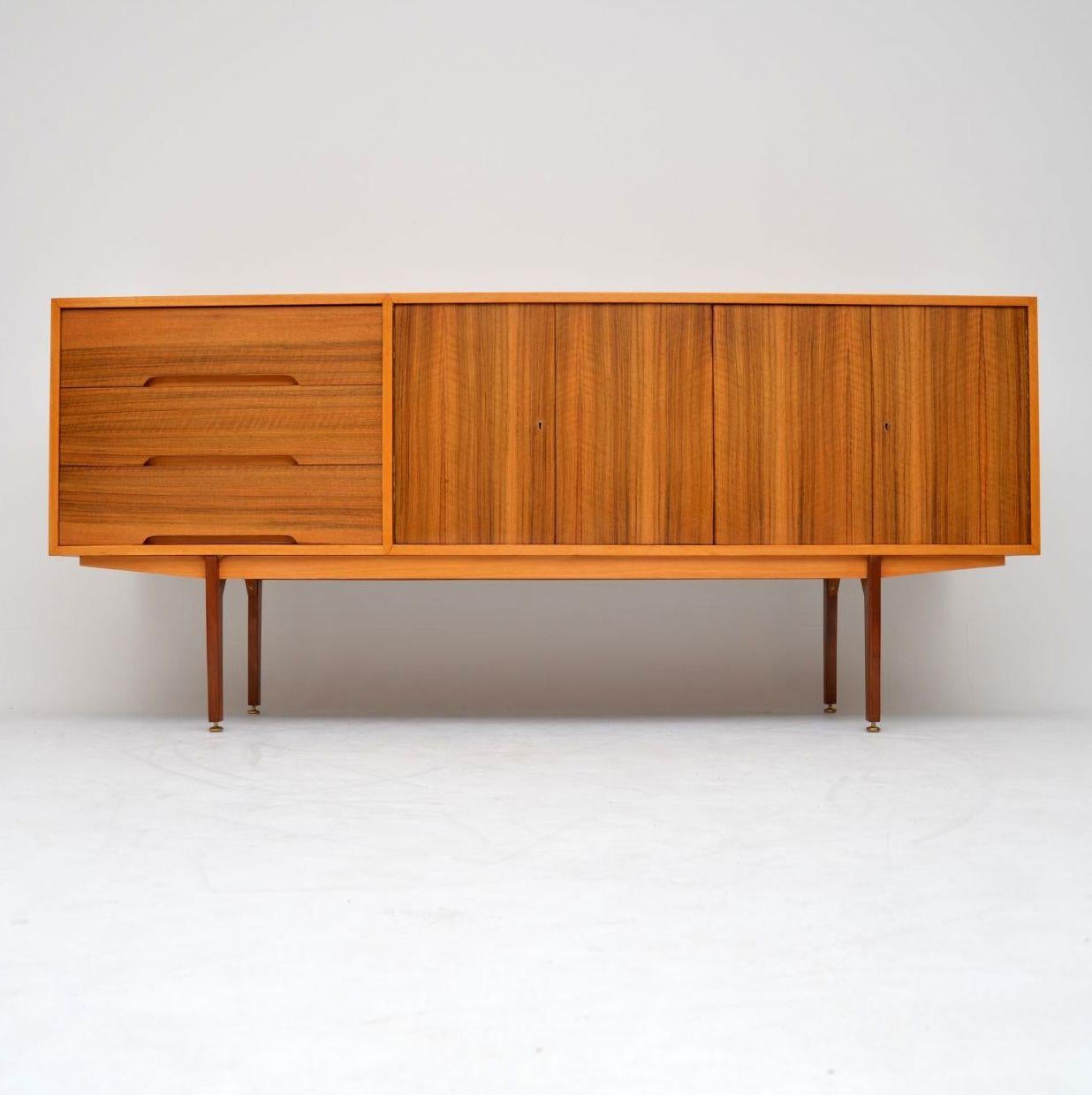 A very stylish and extremely well made vintage sideboard in walnut, this dates from the 1950s. It has a fantastic minimal design, with a beautiful color and lovely grain patterns. The quality of construction is evident throughout, from the finely