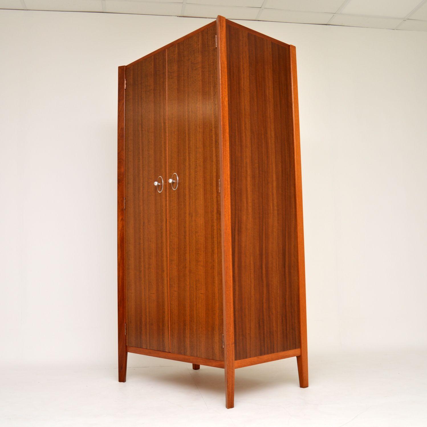 A beautifully designed and extremely well made vintage wardrobe in walnut, this was designed by John Herbert for Younger furniture, it dates from the 1960s. The quality is superb, we have had this completely stripped and re-polished to a very high
