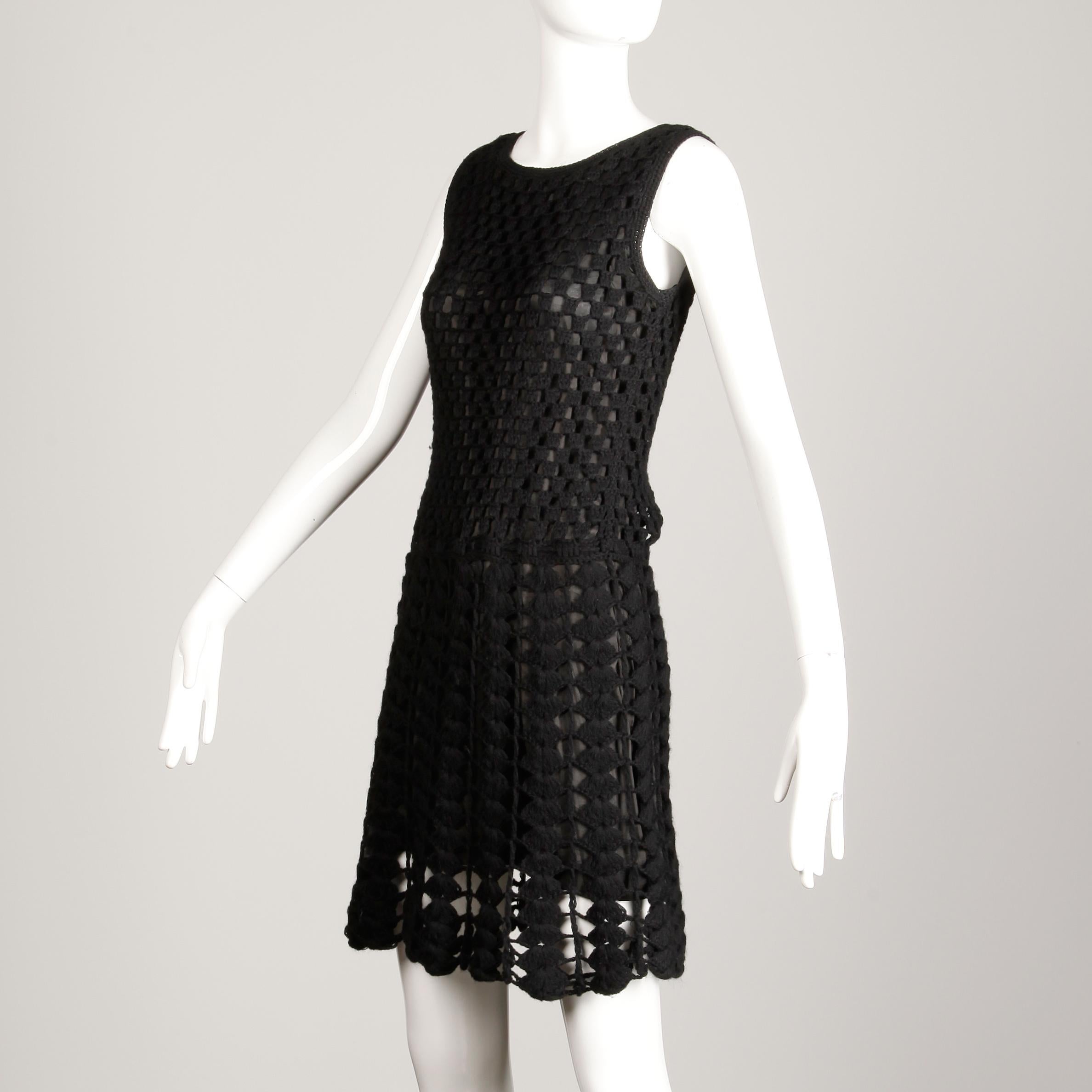 Vintage 1960s vintage black hand crochet dress with lining. Fully lined with no closure (pulls on over the head) tie belt at waist woven into the fabric may be removed if desired. The marked size is small, but the dress will also likely fit a modern