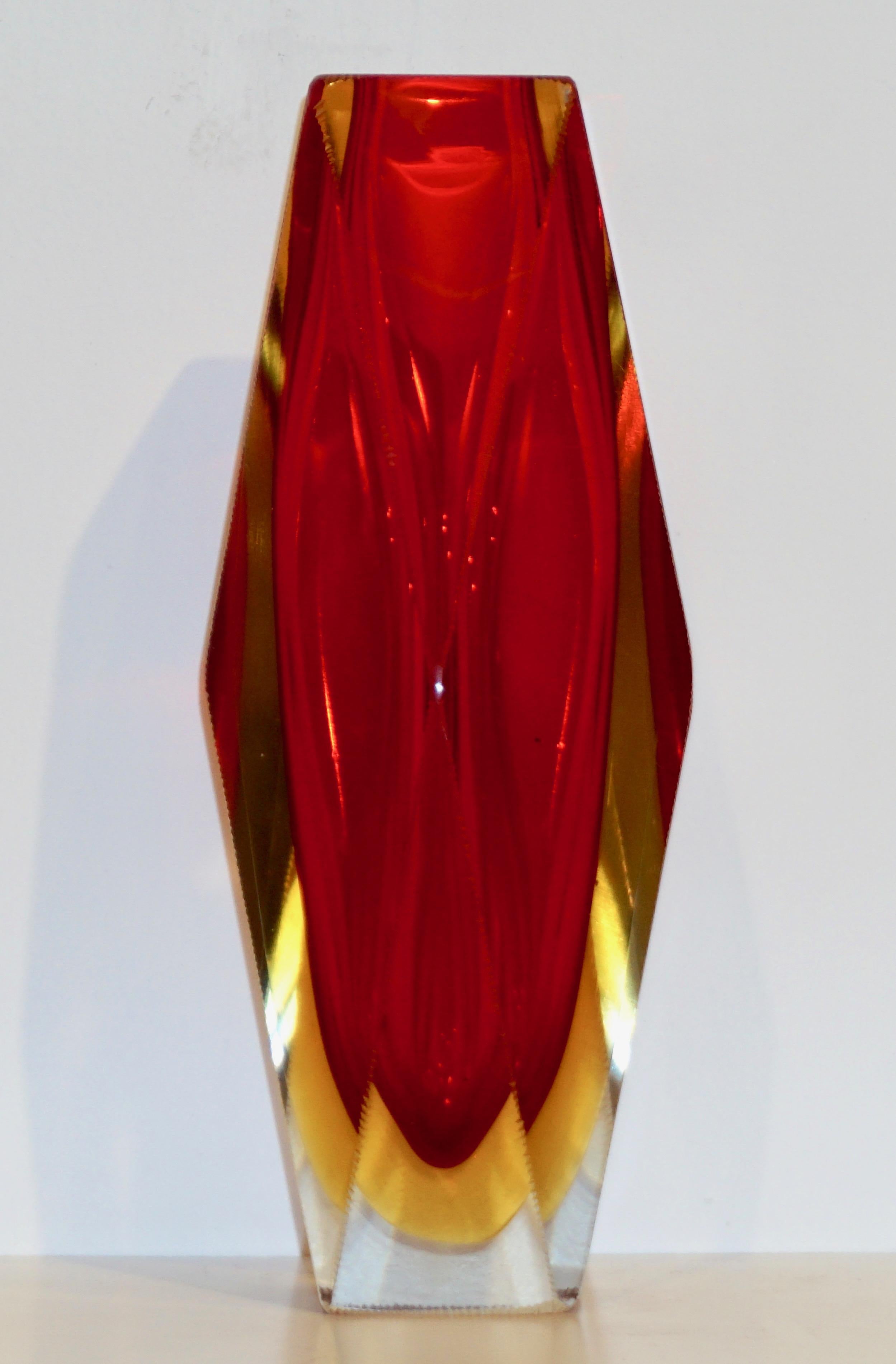 Italian Mid-Century modern polyhedron Murano glass vase in vibrant colors. This organic design with geometric multi-side diamond cut shape by Seguso is typical of Flavio Poli's work, the linear design enhanced by the triple Sommerso technique: the