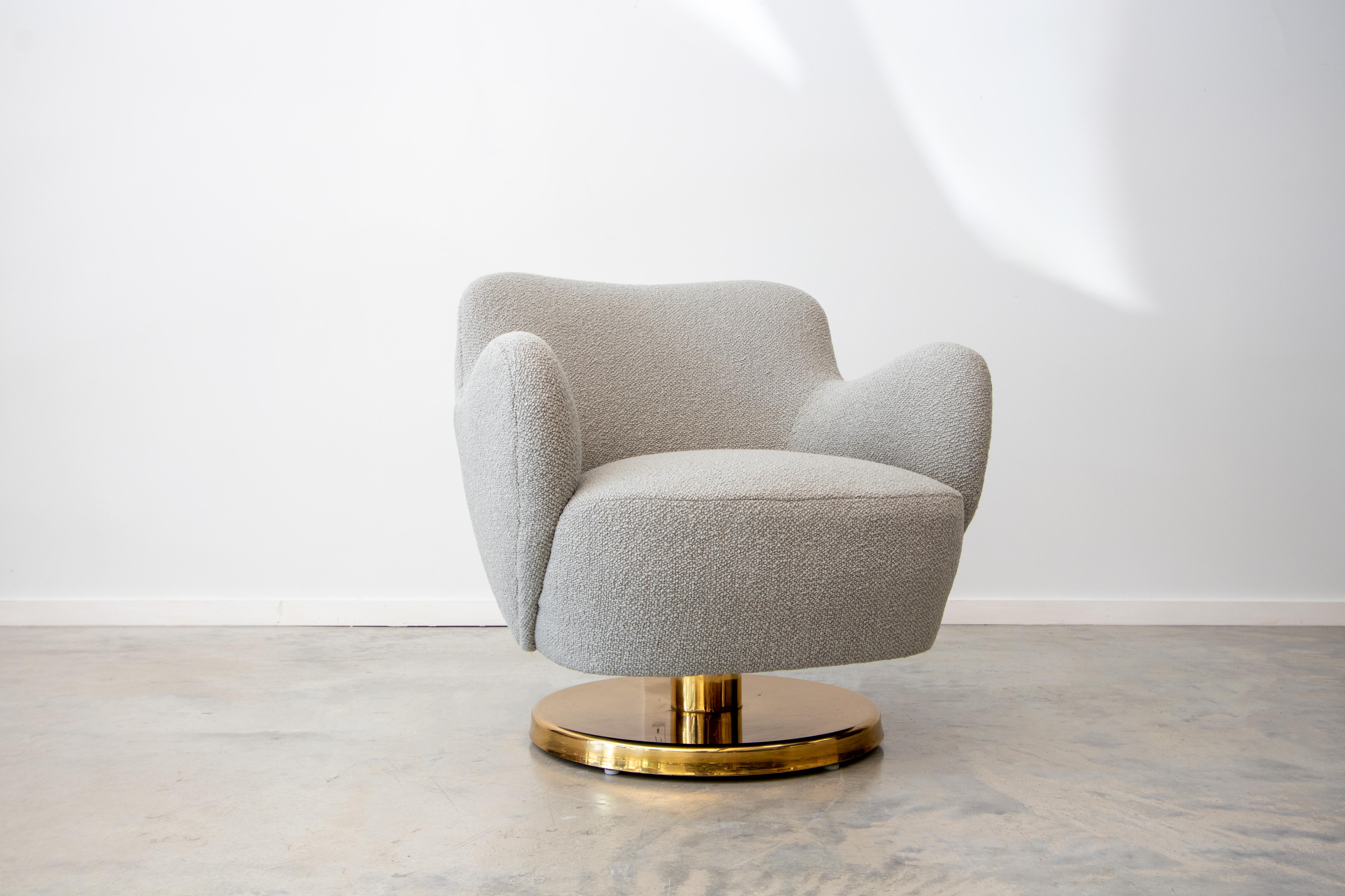 A unique swivel and rocking chair on a brass pedestal base designed by Vladimir Kagan and produced by Kagan-Dreyfuss Inc. This is the model 100a chair originally designed in 1947 but the design was modified by Vladimir Kagan in 1965 to have a brass