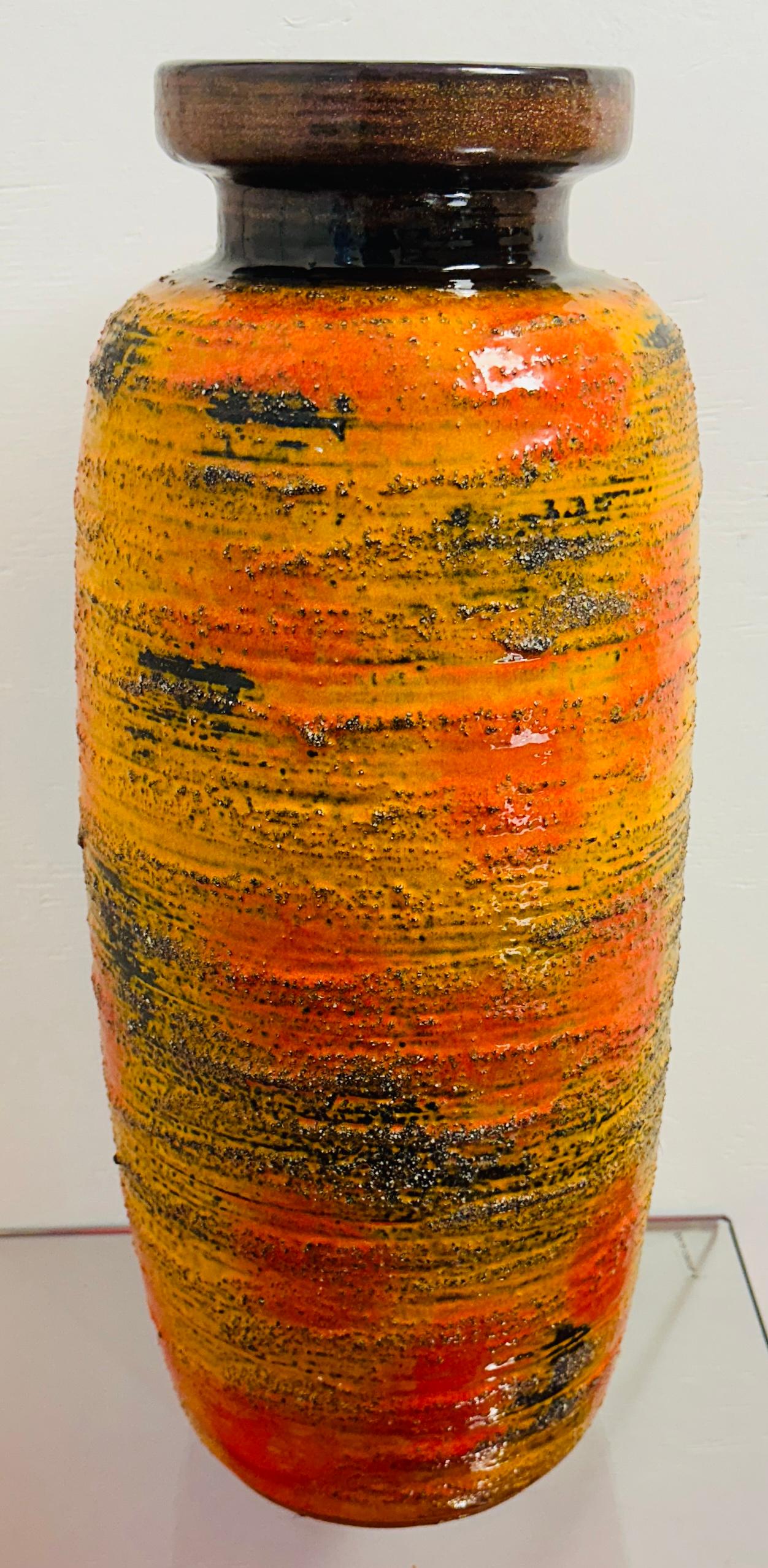 A wonderful 1960s orange, black, brown and ochre glazed floor vase.  The neck and the interior of the vase is brown glaze. Manufactured by Carstens Tonnieshof in West Germany. Model no. 7600-50.  A perfect example of a colourful midcentury modern