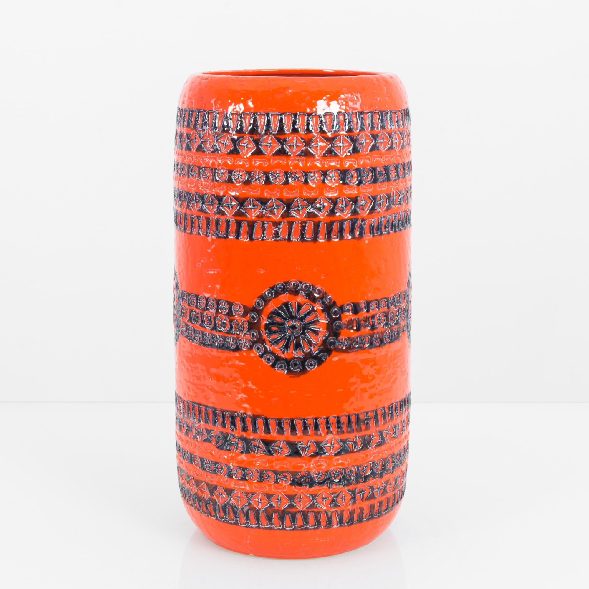 This ceramic vase was made in Germany, circa 1960 and is an eye-catching example of the simple form and decorative nature of West German Art Pottery after the Second World War. This vase’s cylindrical form is glazed with a vivid, deep orange shade.