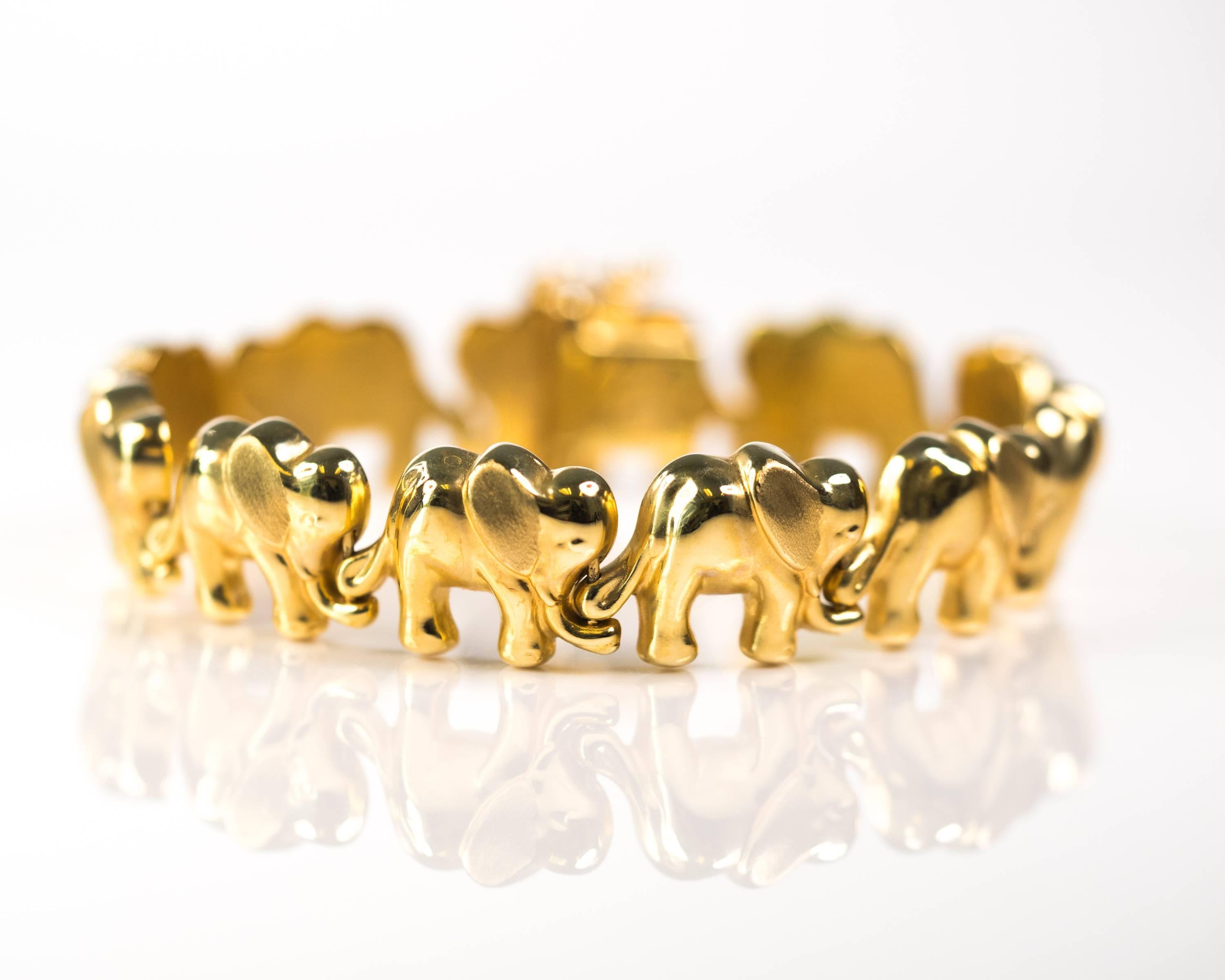 1960s Walking Elephant Bracelet - 14 Karat Yellow Gold

Features 11 Elephants walking Trunk to Tail.
The elephants are crafted from high polish 14 Karat Yellow Gold with matte finish ears. The contrast adds dimension and interest to the bracelet.