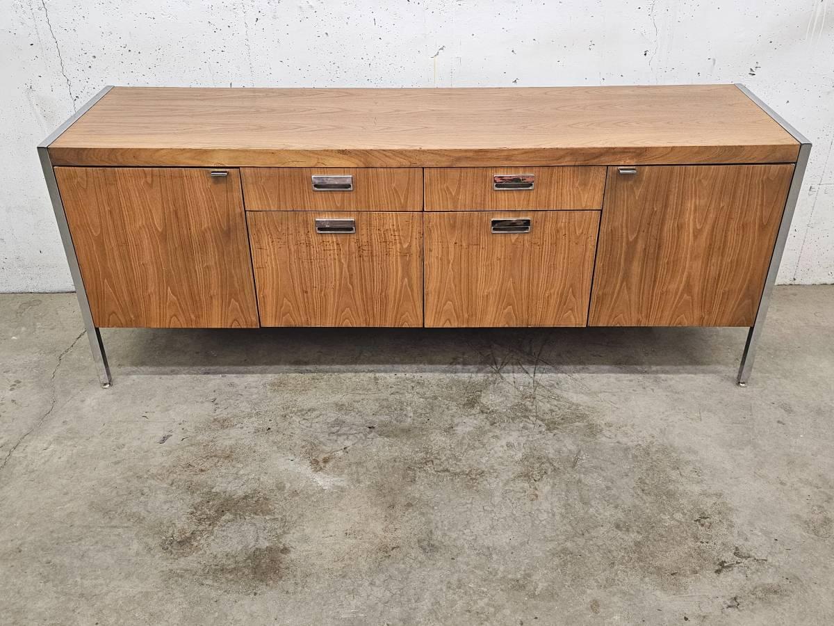 clean mid century modern lines on this exceptionally crafted walnut credenza. Not stamped or marked, but looks to possibly be by Stow & Davis in the late 1960s/early 1970s.

Unique features include polished chrome drawer pulls and legs which lend a
