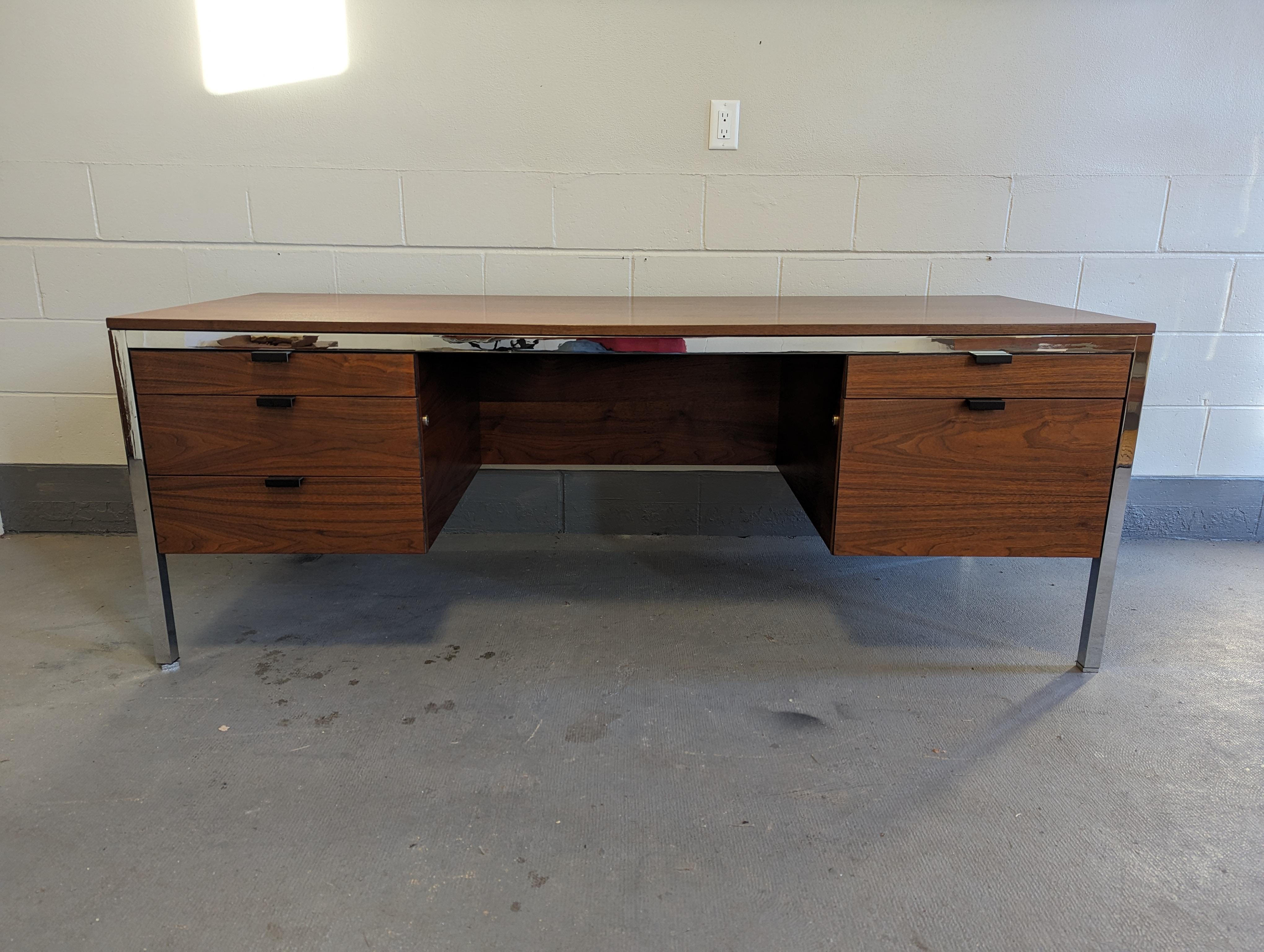 1960s walnut and chrome executive desk in the style of Florence Knoll.

Nice walnut grain and color throughout, including exceptional 76x28 work surface.

Features 5 drawers, complete with dividers and pencil holder. Finished back, beautiful from