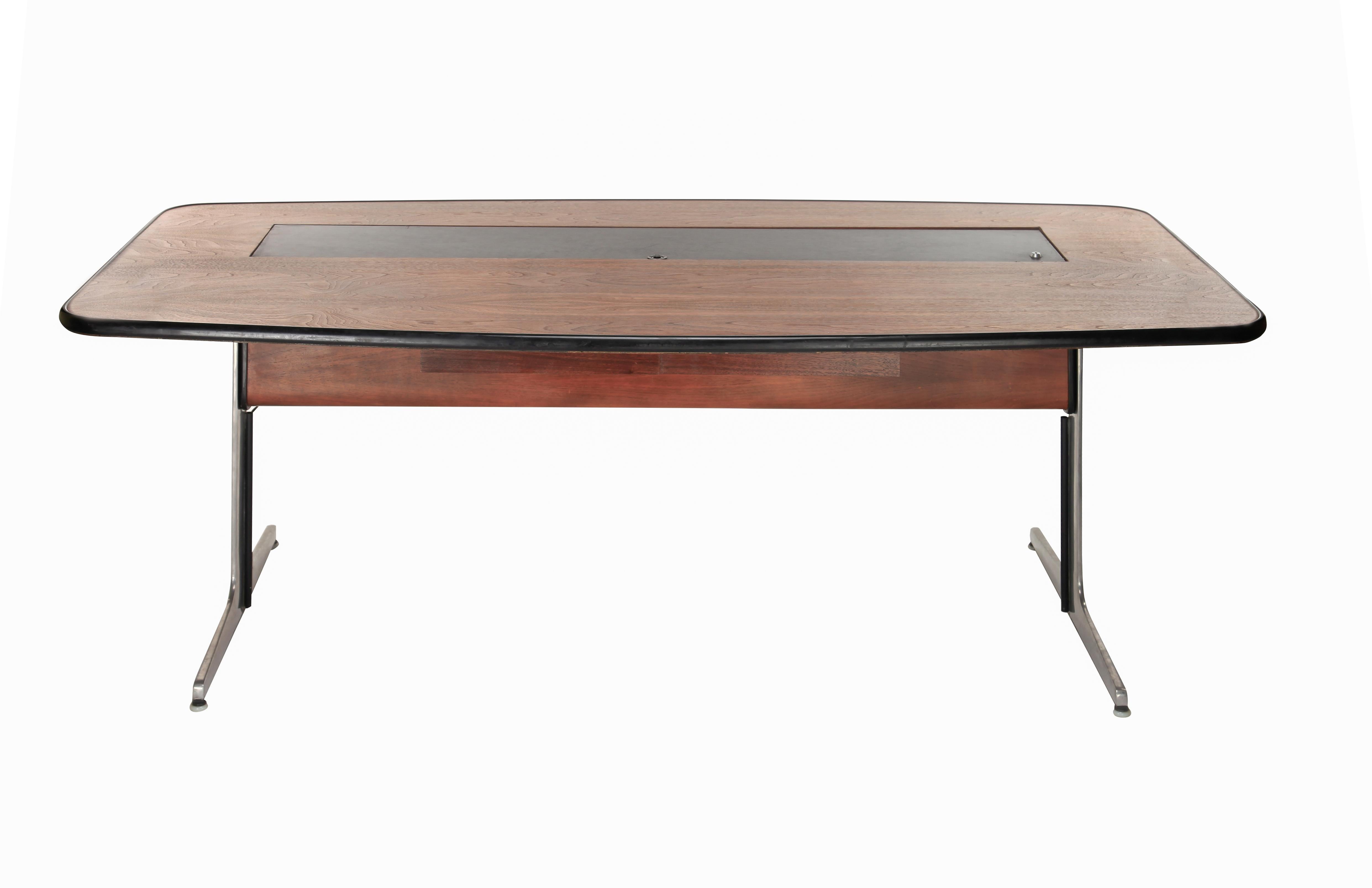 1960s walnut and leather desk by George Nelson for Herman Miller. Executed in walnut with leather lift top (with key) covering center filing compartment, which illuminates and contains two fitted drawers on a cantilevered brushed aluminum
