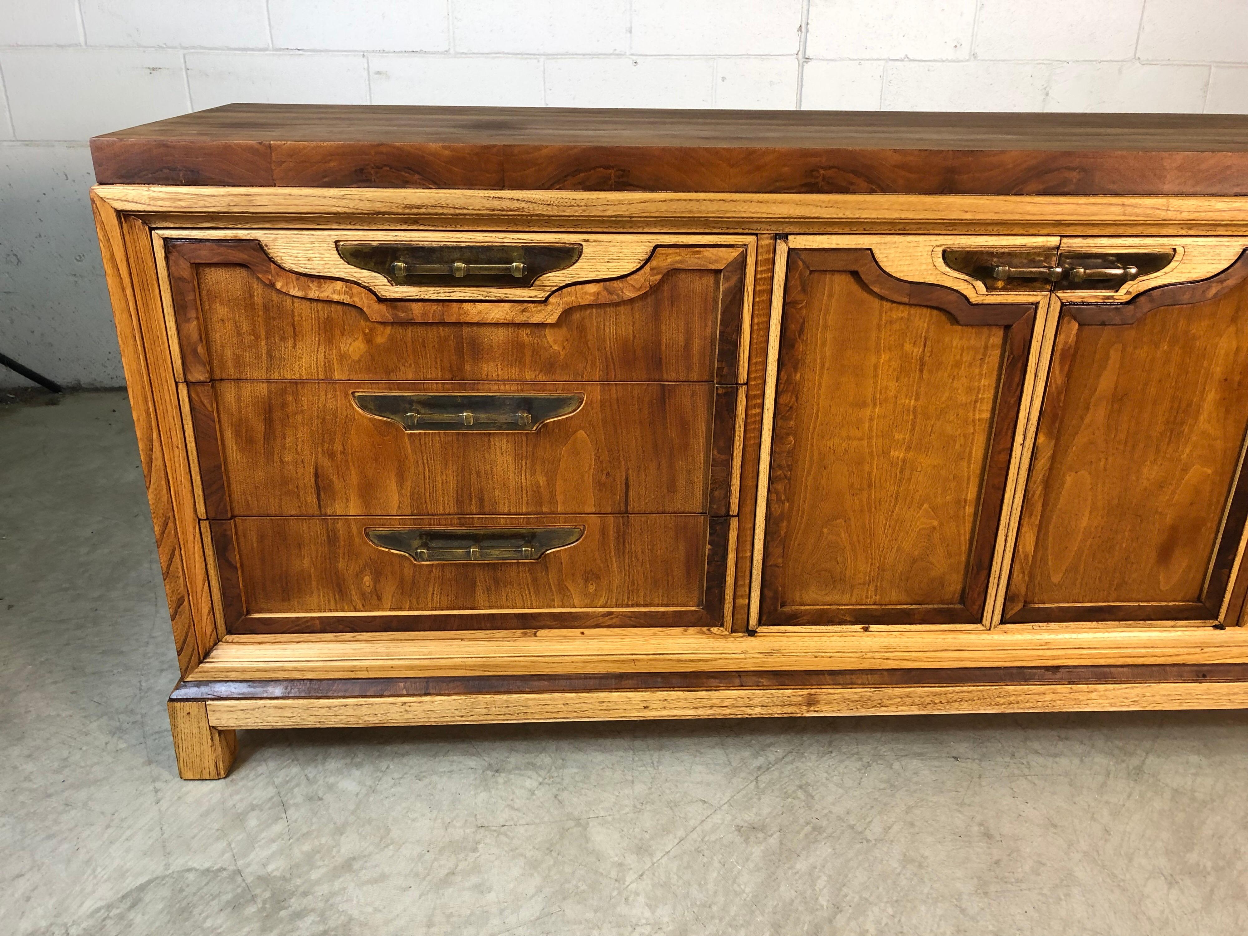 Mid-Century Modern 1960s walnut and ashwood low dresser with nine drawers for storage. The dresser is by Fancher Furniture Co and has been refinished to show the mix of woods. The dresser is in excellent refinished condition.