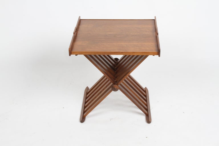 Mid-Century Modern walnut campaign style folding X form tray, side or end table with removable tray. Designed by Stewart MacDougall and Kipp Stewart for Drexel Furniture Company, Declaration Line, Mod. no. 881-401 Folding Table 558. In very nice