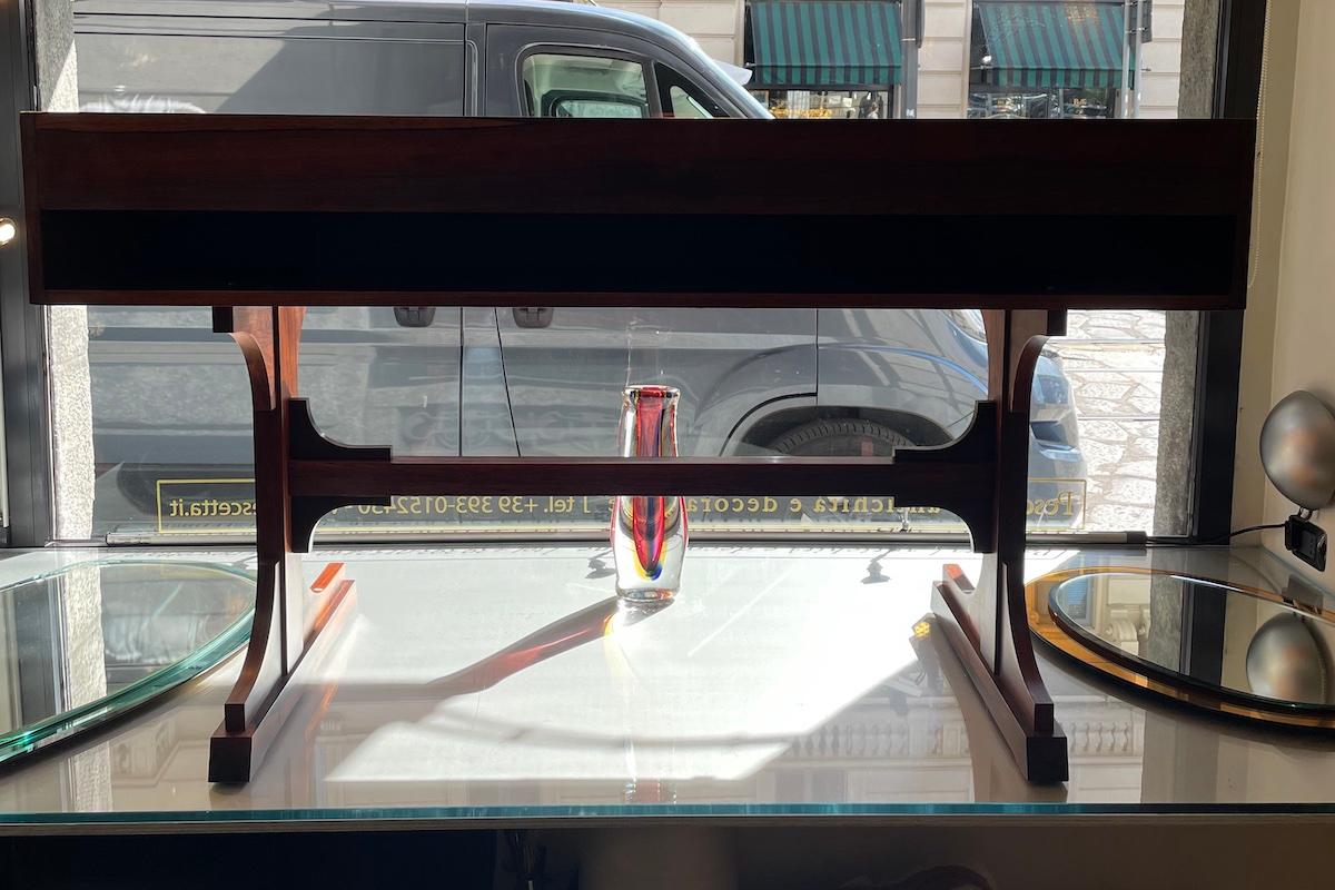 1960s walnut desk with two drawers and an open central compartment. The structure rests on two supporting legs and is finely finished on both sides, allowing placement in the center of a room.

Measurements: W 149 × D 61.5 × H 85 cm.

Price INCLUDES