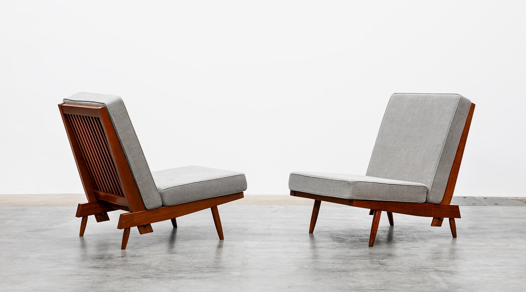 Lounge chairs, walnut, new upholstery in grey by George Nakashima, USA, 1962.

Magnificent set of lounge chairs crafted from American walnut by George Nakashima himself in elaborate handwork. The light feet and frame combined with the generous