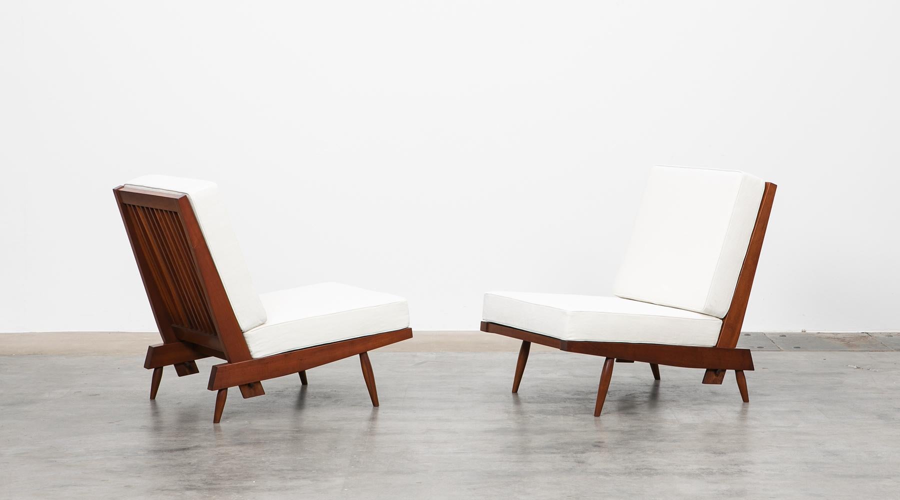 Lounge chairs, walnut, by George Nakashima

Staggering set of lounge chairs constructed with American walnut through handwork by George Nakashima himself. The light feet and frame combined with the generous seating cushions provide style and
