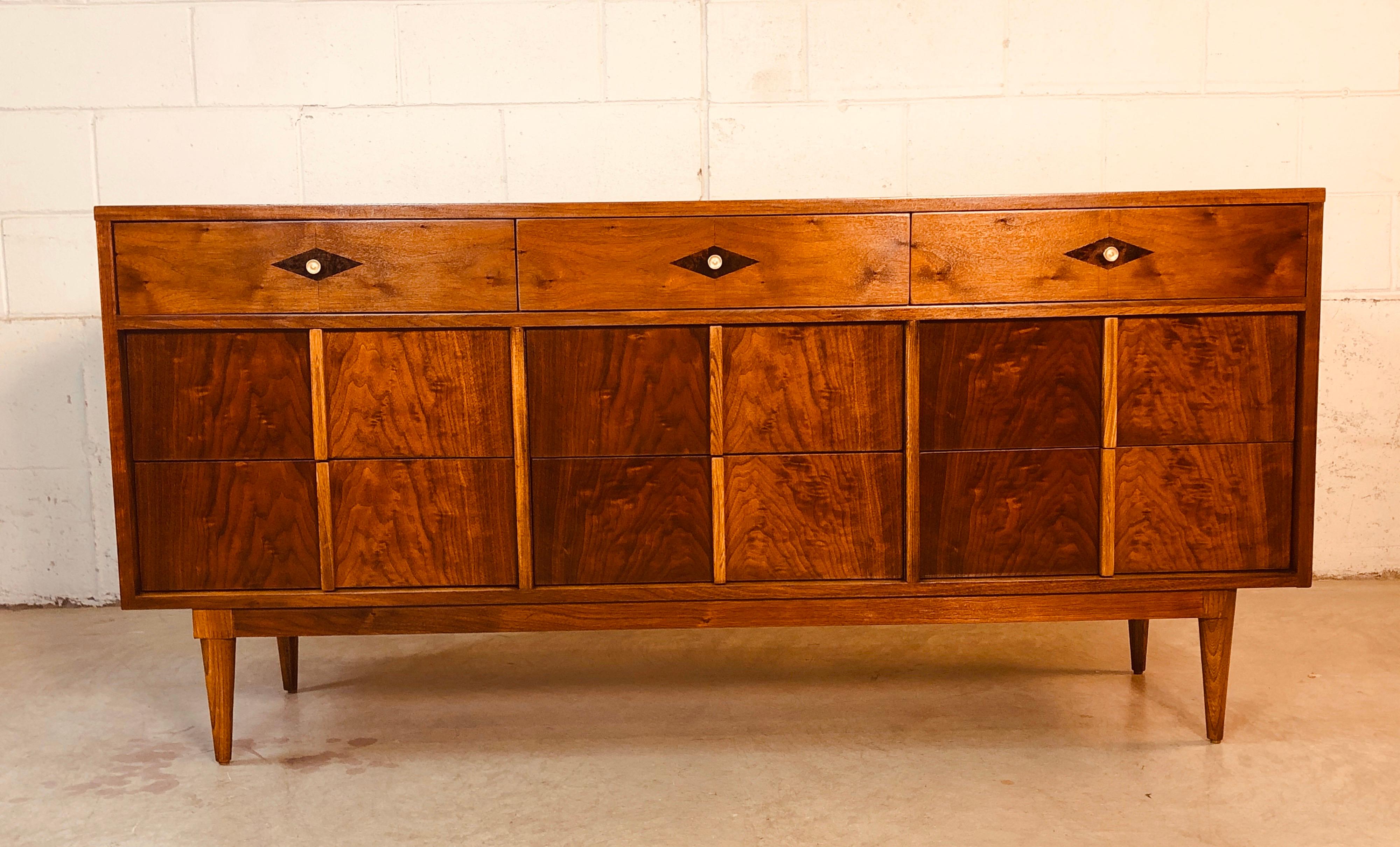 Vintage 1960s walnut and ash wood nine drawer dresser with rosewood diamond accent on the top three drawers. The dresser is made by Basic-Witz and is marked in the drawer. Excellent refinished condition.