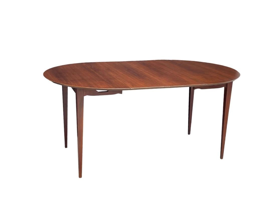 A rare petite size and lines Table custom made by Specialty Woodcraft Inc. of N.J. Comes with 2 leaves that are 12” each and match table beautifully 