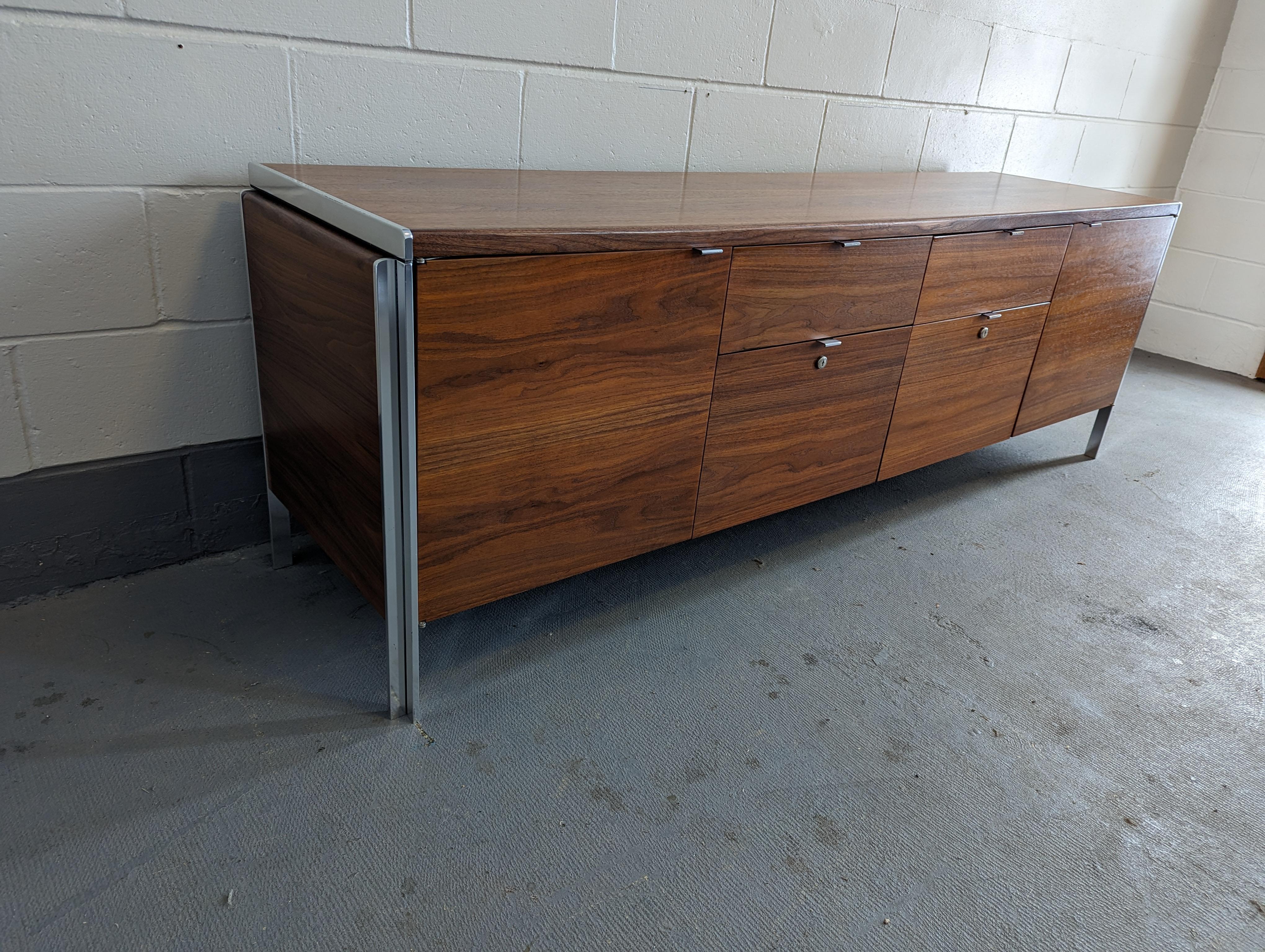 Stunning walnut color and figure present on this long sideboard designed by Alexis Yermakov for Stow Davis' 