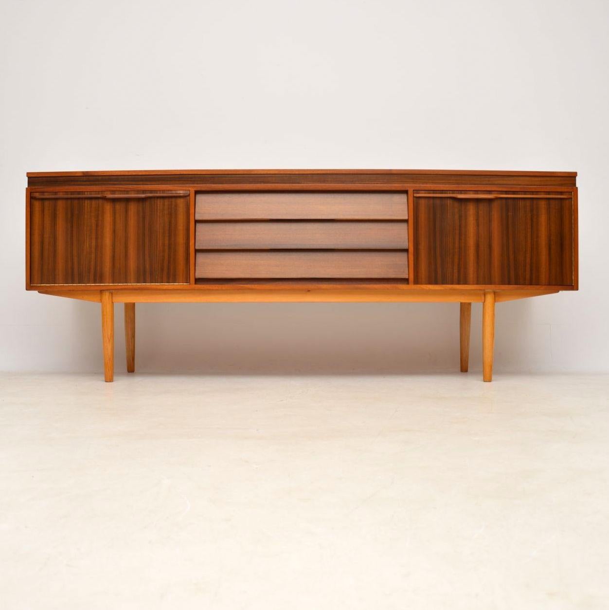 A stylish and extremely well made vintage sideboard in Walnut, this was designed by Neil Morris and was made by Morris of Glasgow in the 1960’s. We have had this stripped and re-polished to a very high standard, the condition is superb
