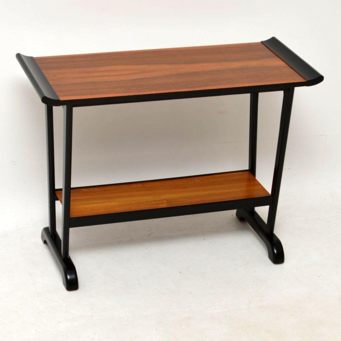 A beautifully designed vintage walnut side table, this dates from the 1960’s. It’s a great size to be used as a TV stand, or side / entry table. We have had this stripped and re-polished to a very high standard, the condition is superb