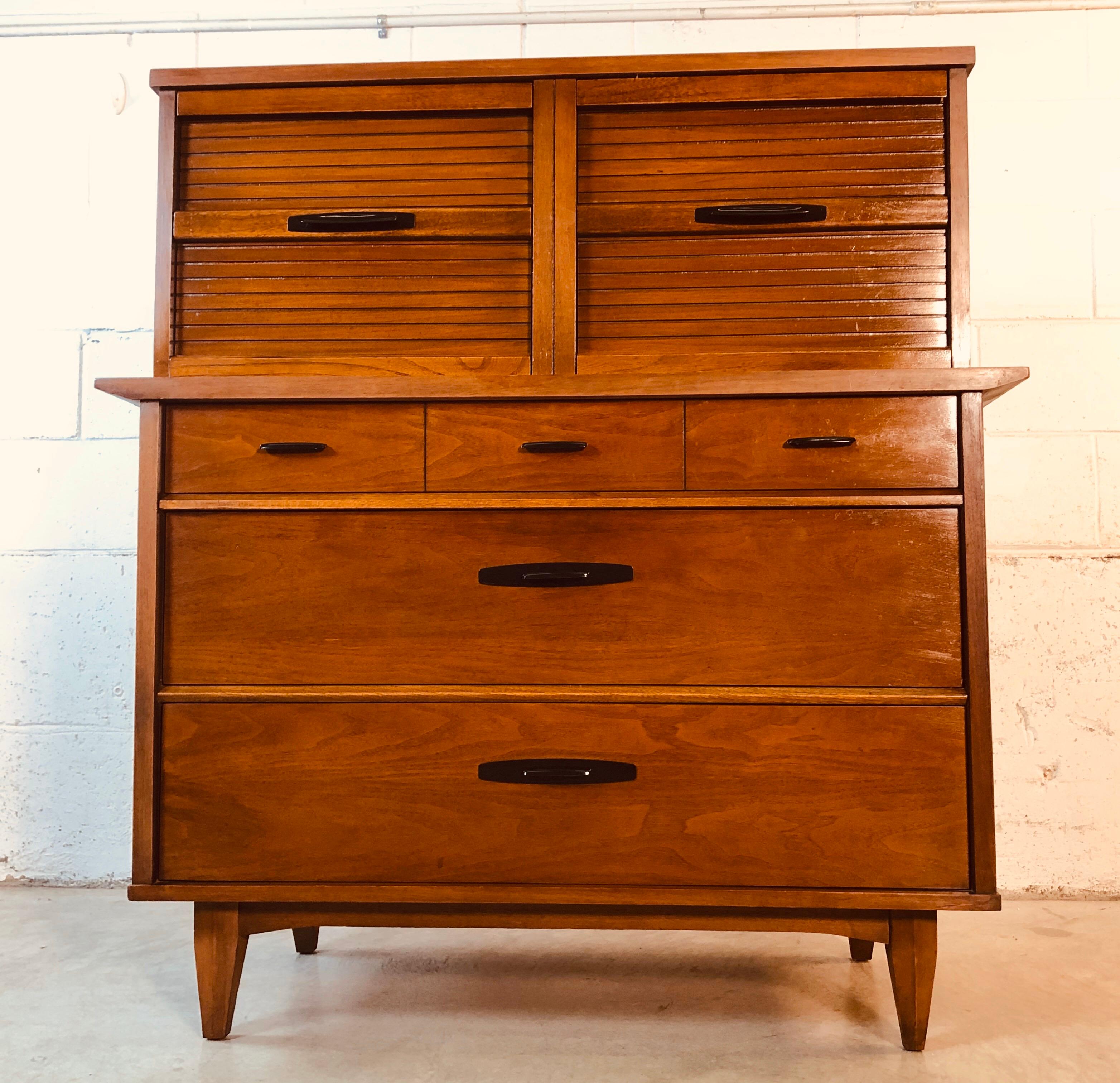Vintage 1960s walnut wood tall bedroom dresser by Dixie Furniture Co. The dresser has seven drawers for storage. The bottom drawers are 6” H for amble storage. The dresser has been restored and is in excellent used condition. Marked in the drawer.