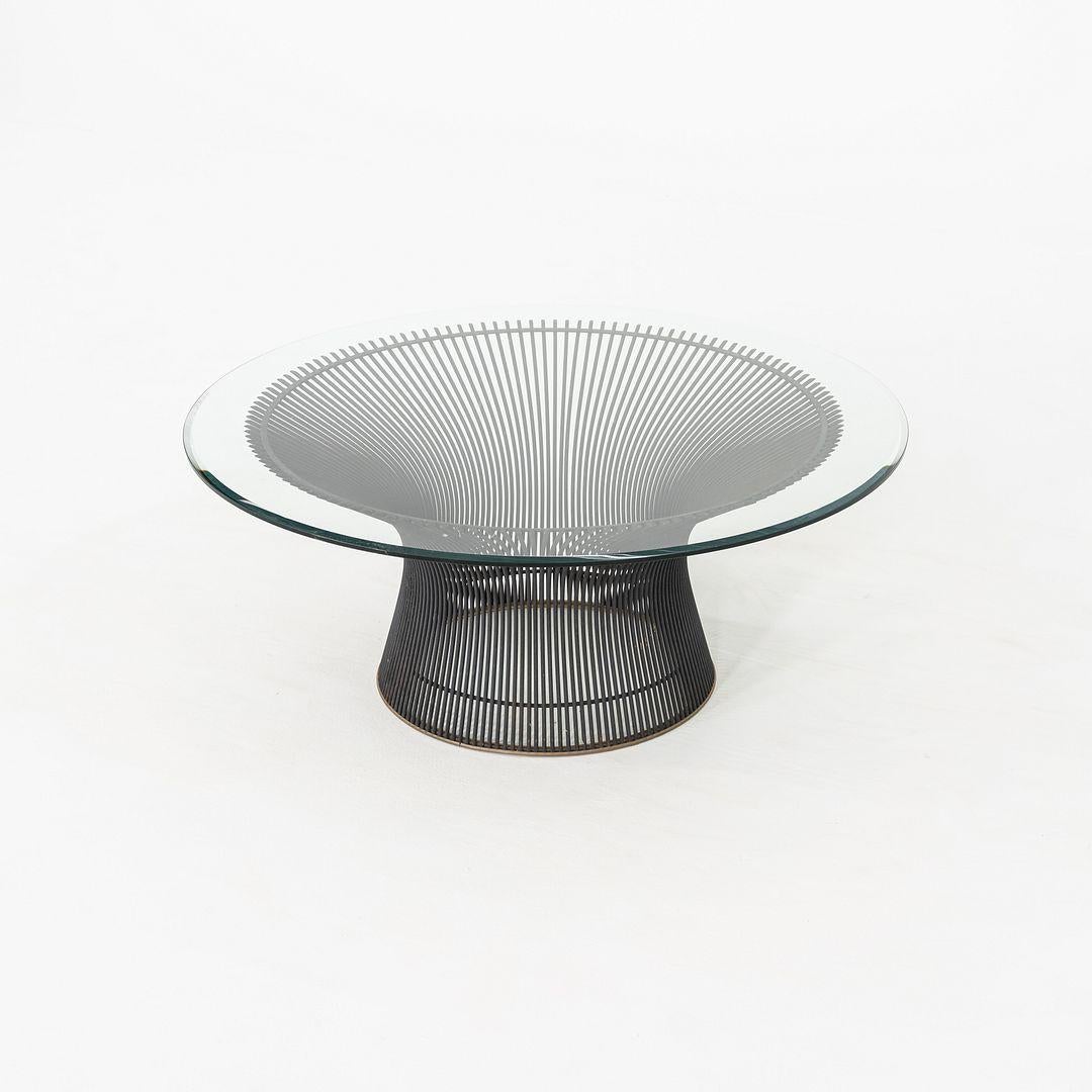 This is a Platner Coffee Table, originally designed by Warren Platner for Knoll in 1966. This early example dates to the 1960s. The design features a nickel-chromed steel base, and has a glass top with beveled edge. The base is constructed of steel