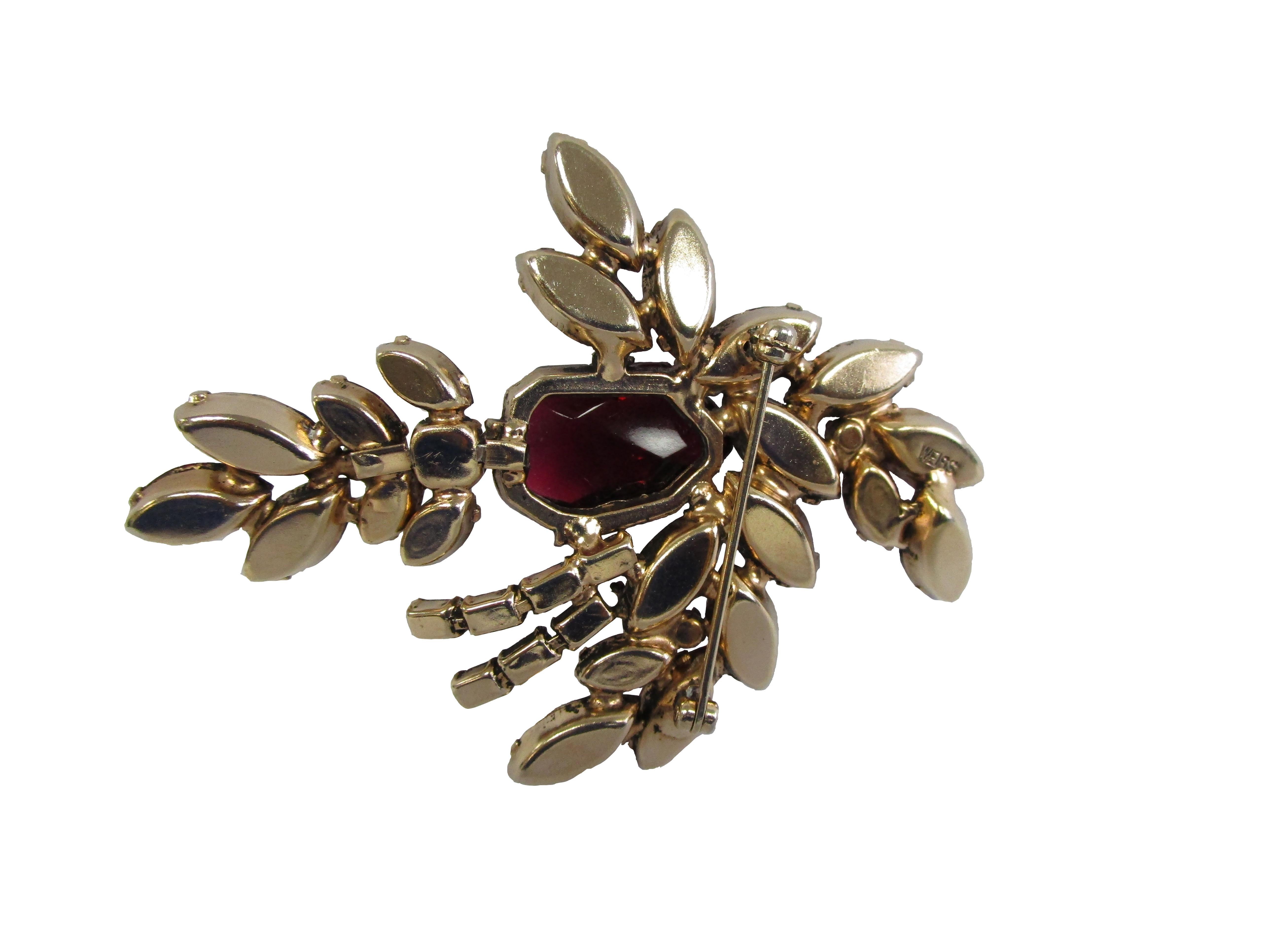 1960's Weiss  Festive Multicolored Cluster Gem Evening Brooch

Vibrantly colorful brooch from Weiss!
This brooch features an explosion of gems clusters centered by a intricately cut grape gem.
The bottom of the brooch is a adorned with a jeweled