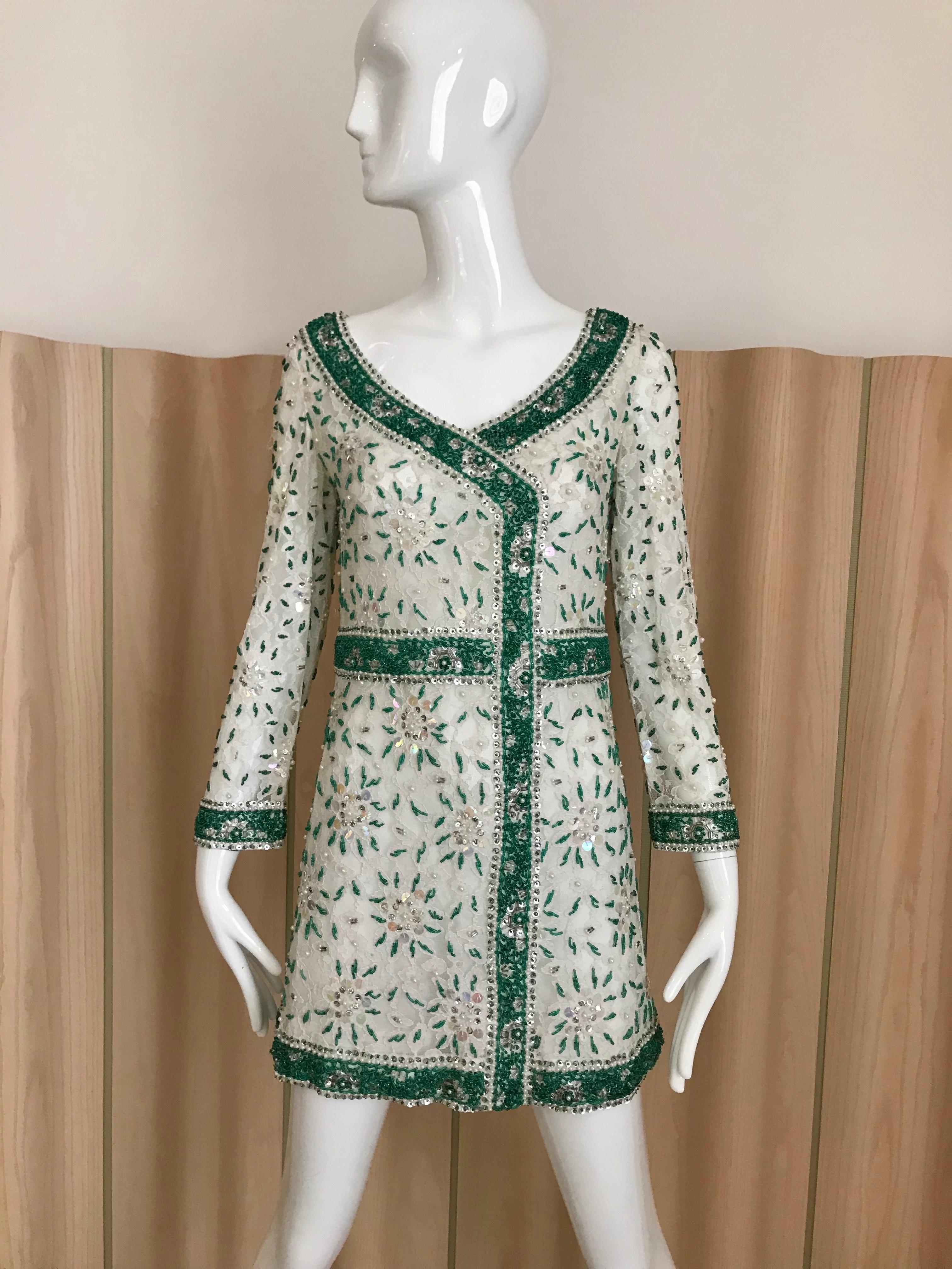 Vintage 1960s Intricate White and Green beaded sequin floral pattern on white lace mini cocktail dress.
Dress is lined in silk but sleeve in unlined.
Size: best fit size 0/2 or 4 
Bust: 34 inches / Waist: 28 inches/ Hip: 34.5 inches / total length :