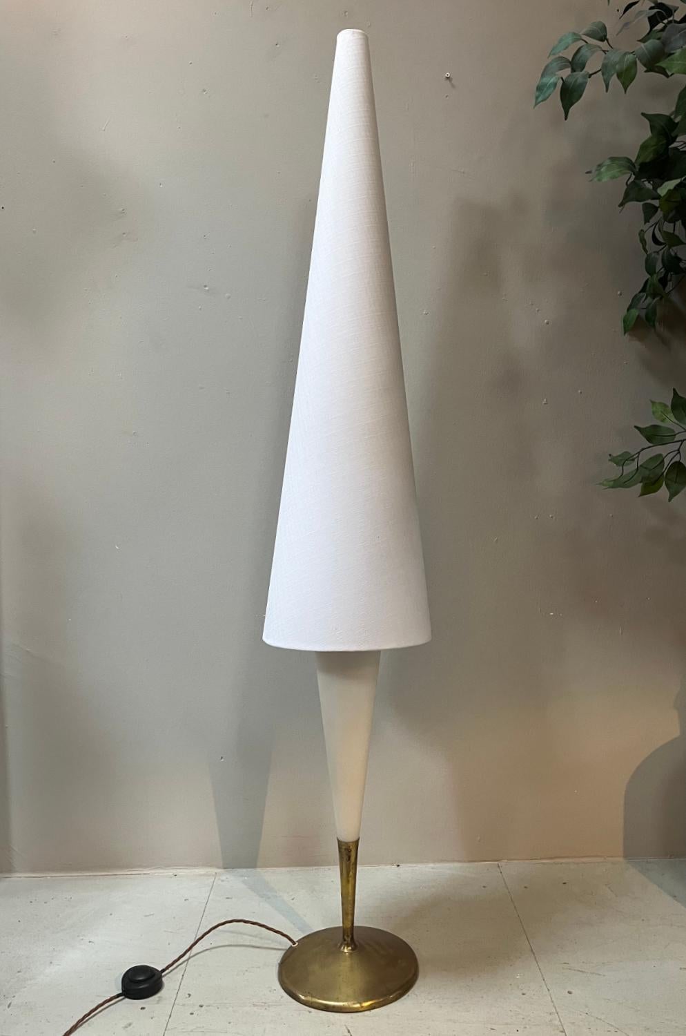 An outrageous 1960s Continental floor lamp attributed to Maison Arlus. There are no makers marks, however this piece was bought in France. This Space Age looking standard lamp sits on a circular brass base, the stem rises up to meet a conical white
