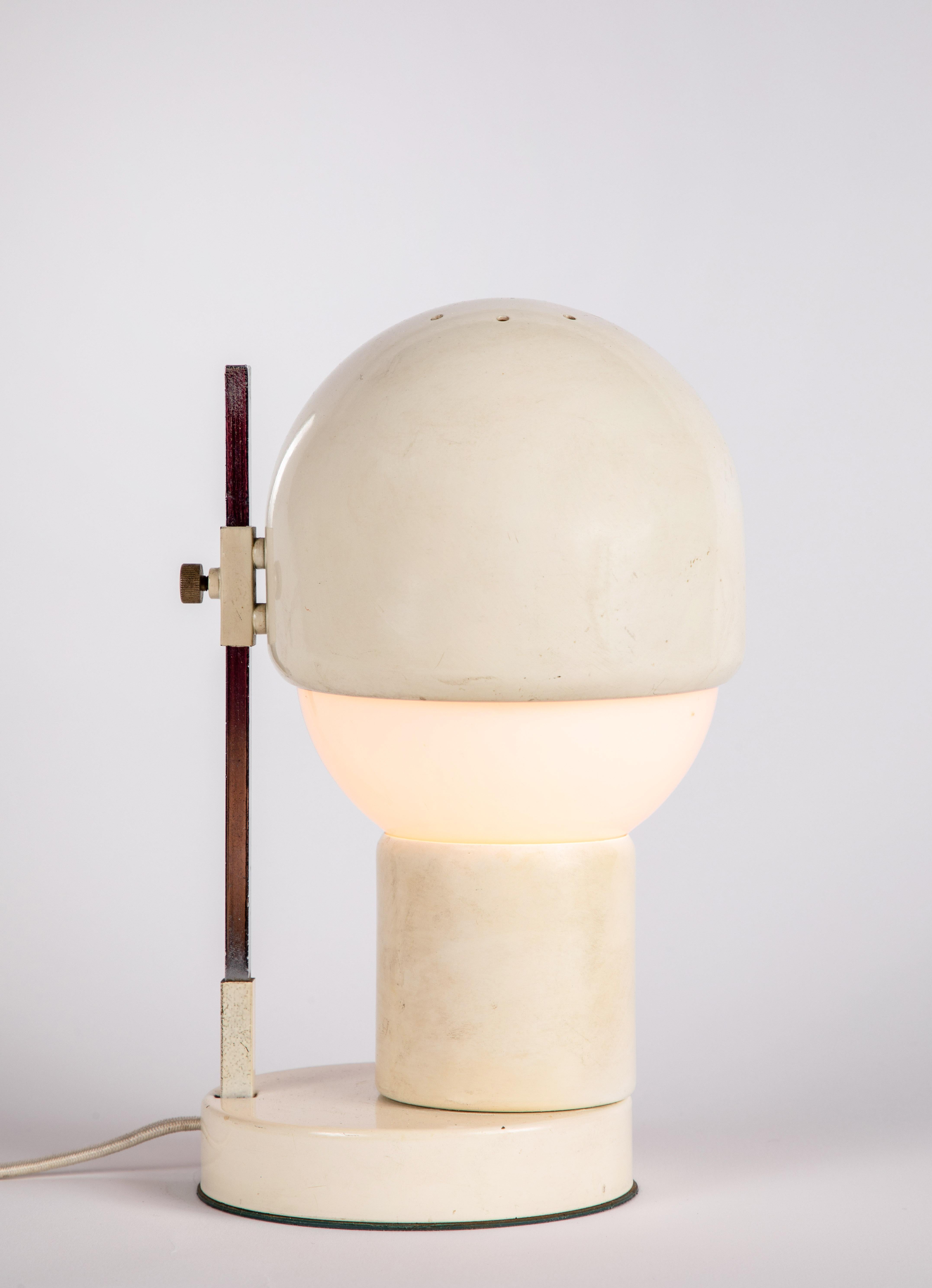 1960s white glass and metal table lamp attributed to Angelo Lelli for Arredoluce. A refined design executed in white painted metal, nickel and blown opaline glass. Metal shade can be adjusted up and down over the glass. An exquisite example highly