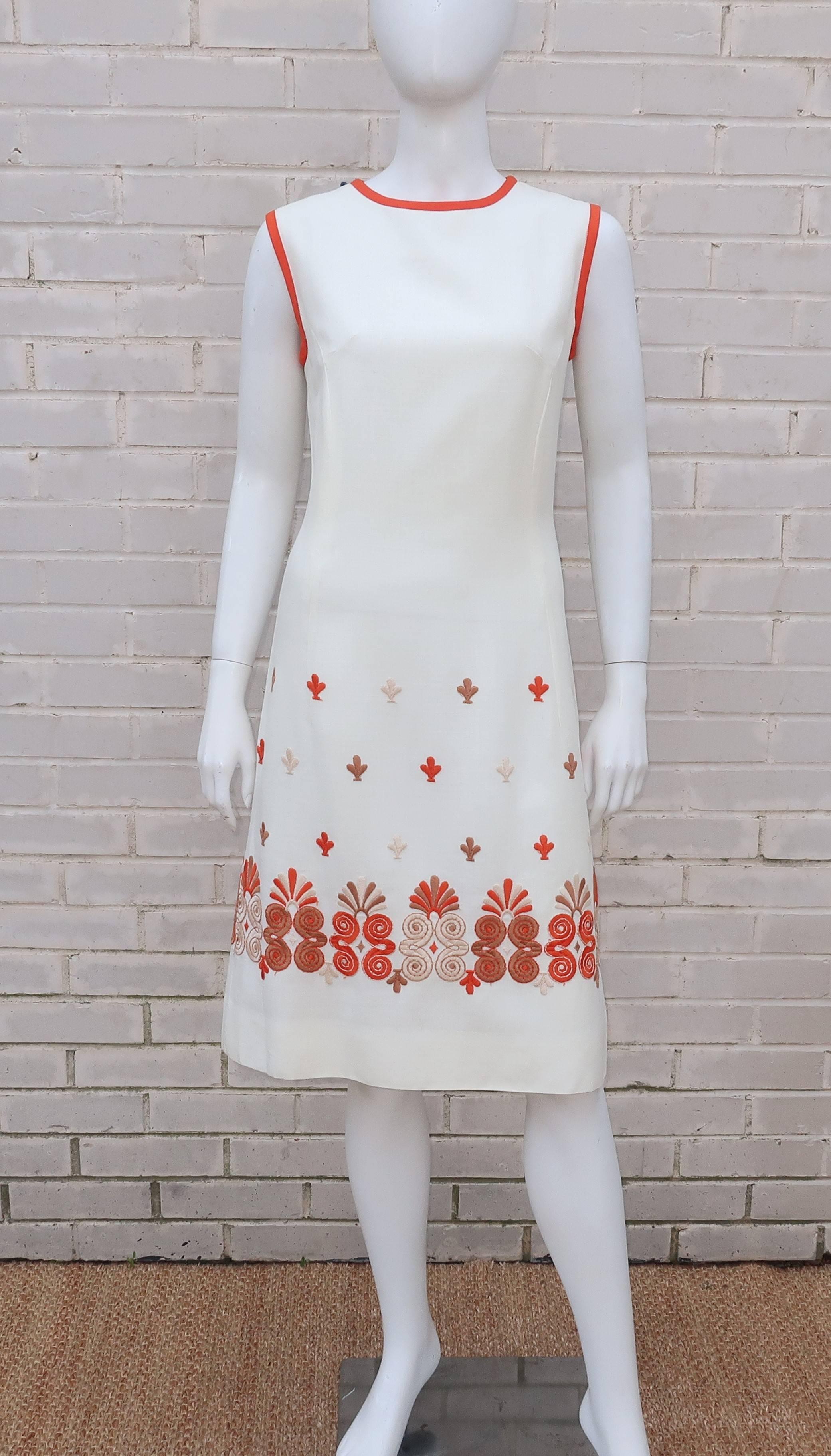 Take a simple 1960’s shift dress in an ivory white linen and add a graphic tiki style exotic embroidery at the hem for a crisp warm weather look that can go from day to evening with a quick change of accessories.  The embroidery incorporates a
