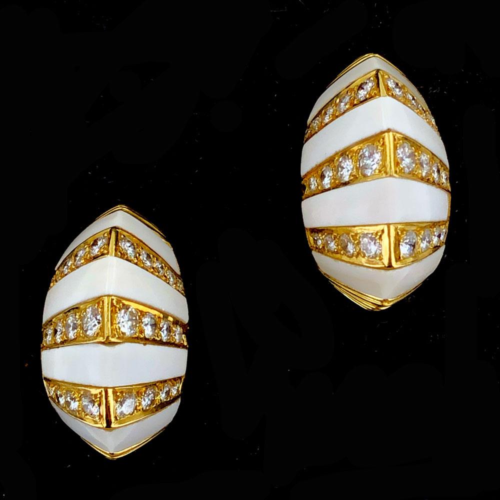 Stunning 1960's white onyx diamond earrings fashioned in 18 karat yellow gold. The earrings measure 15 x 25mm and feature 48 round brilliant cut diamonds weighing 2.32 carats. The  vibrant white diamonds are graded F color and VS clarity. Clip backs