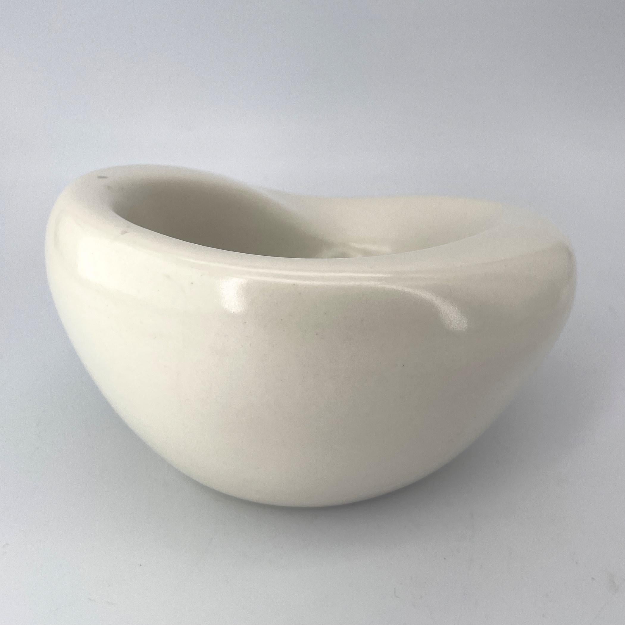 A deep off-white coffee table pottery bowl with abstract volcanic bottom interior. Heavily influenced by the work of Georges Jouve, with the thick freeform walls.