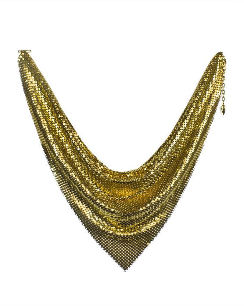 Known for inventing metal mesh at the turn of the last century, this Whiting & Davis goldtone mesh scarf necklace from the 1960's is stylish, chic and an iconic piece from the infamous accessory designers. Reinvented several times over the years for