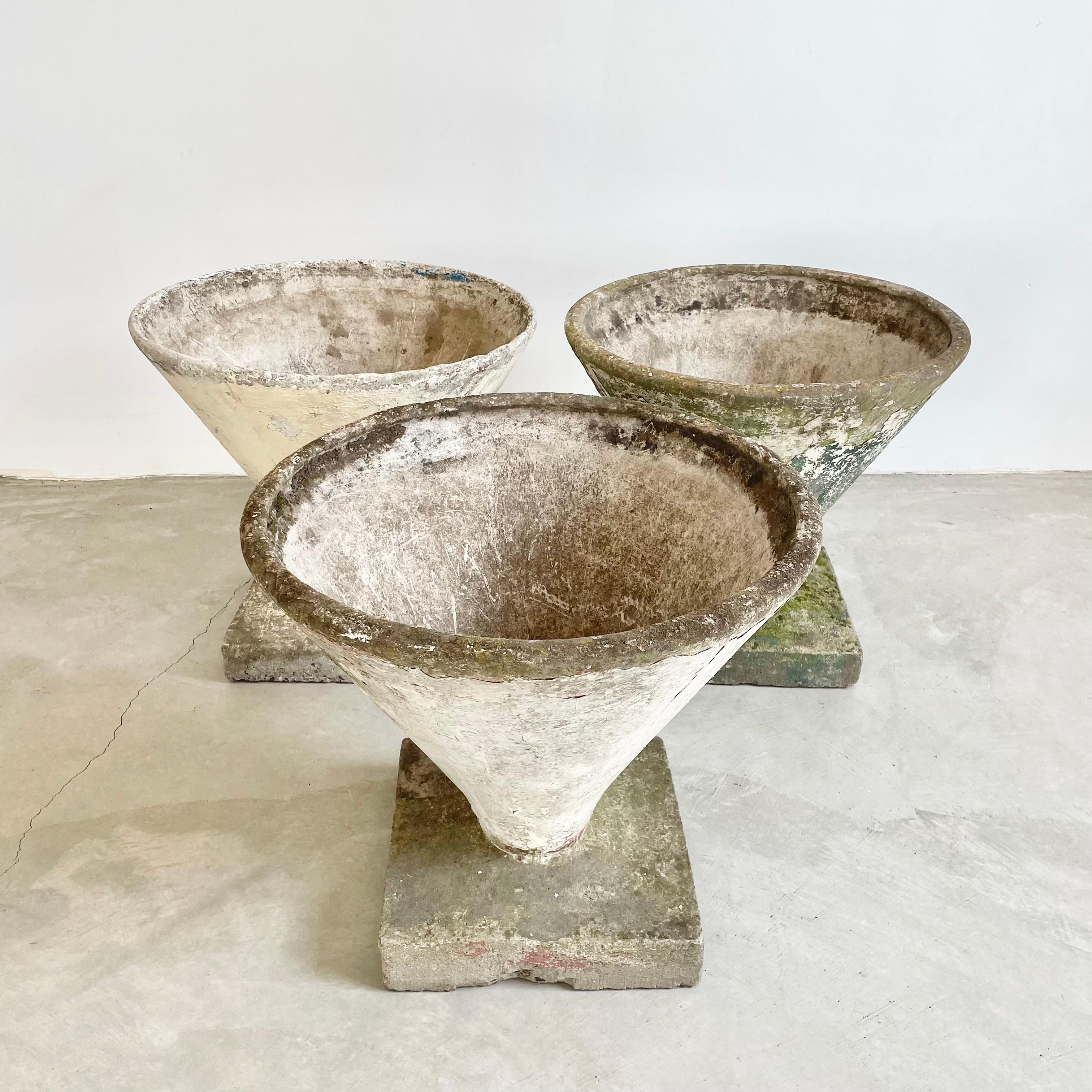 Substantial concrete cone planter by Swiss architect Willy Guhl. Thick cement pedestal base for stability. Heavy and substantial. Unusual shape. Made in the 1960s in Switzerland. 3 available. Different patina to each planter.
Priced individually.