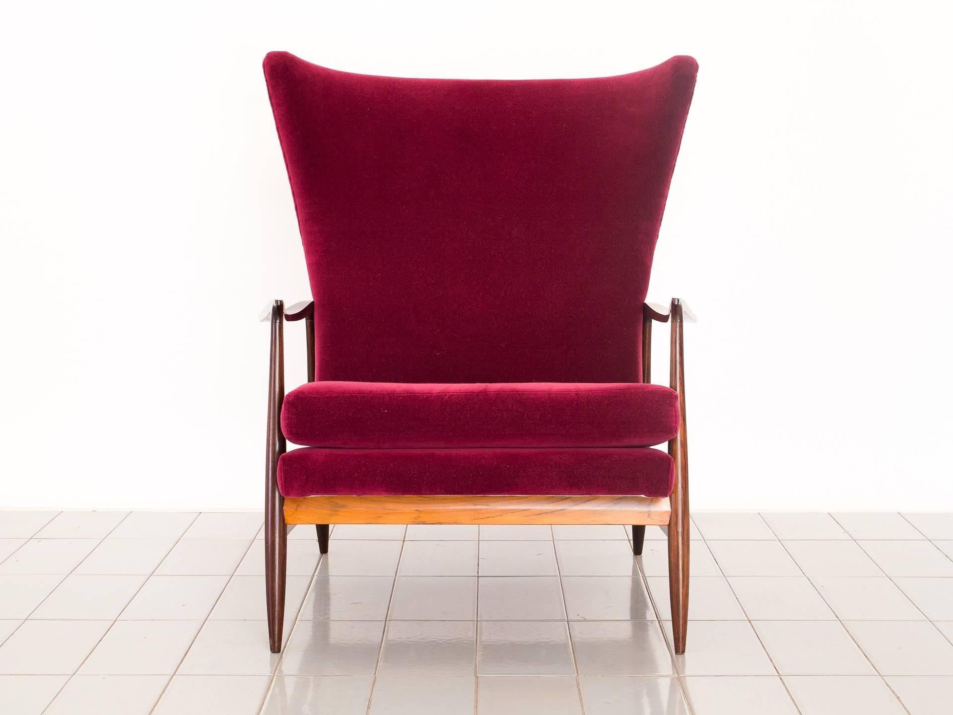 This beautiful Brazilian rosewood wingback lounger was produced by Móveis Cimo, one of the biggest furniture companies in mid century Brazil. Upholstered in 100% cotton velvet, and new refinishing of the wood. The chair has a factory production