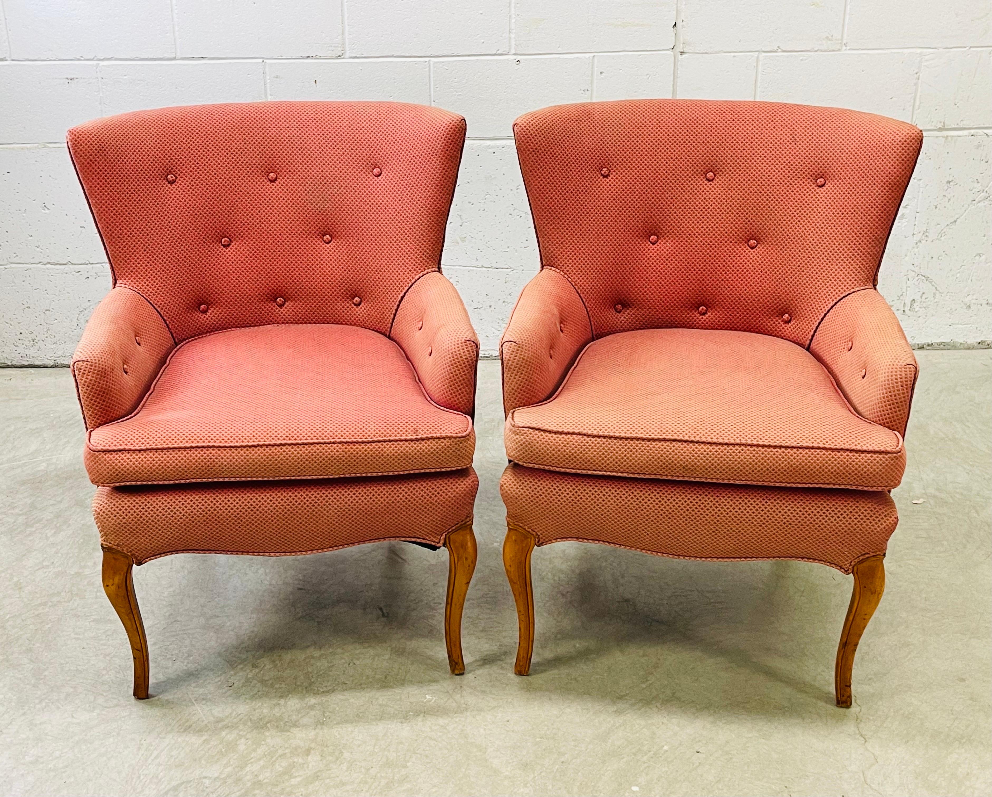 Vintage 1960s pair of tufted winged back Provincial style arm chairs. The chairs have cabriole style legs with a large winged back design. Comfortable and sturdy, these chairs need to be recovered. No marks.