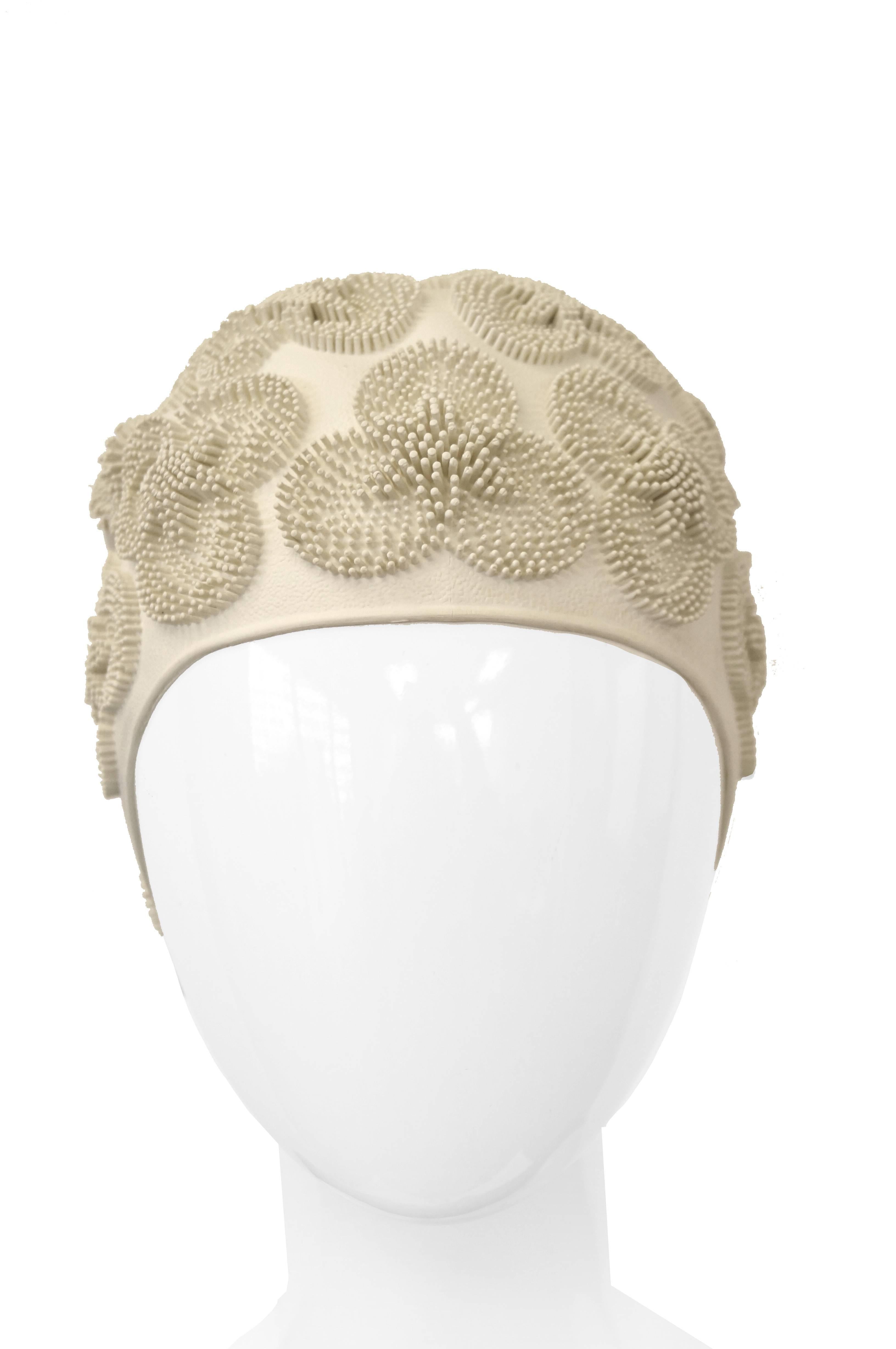 Floral 1950s bathing beauty winter white swim cap! The elastic rubber cap features a three - petal flower print with three - dimensional rubber posts. 

Small-Medium