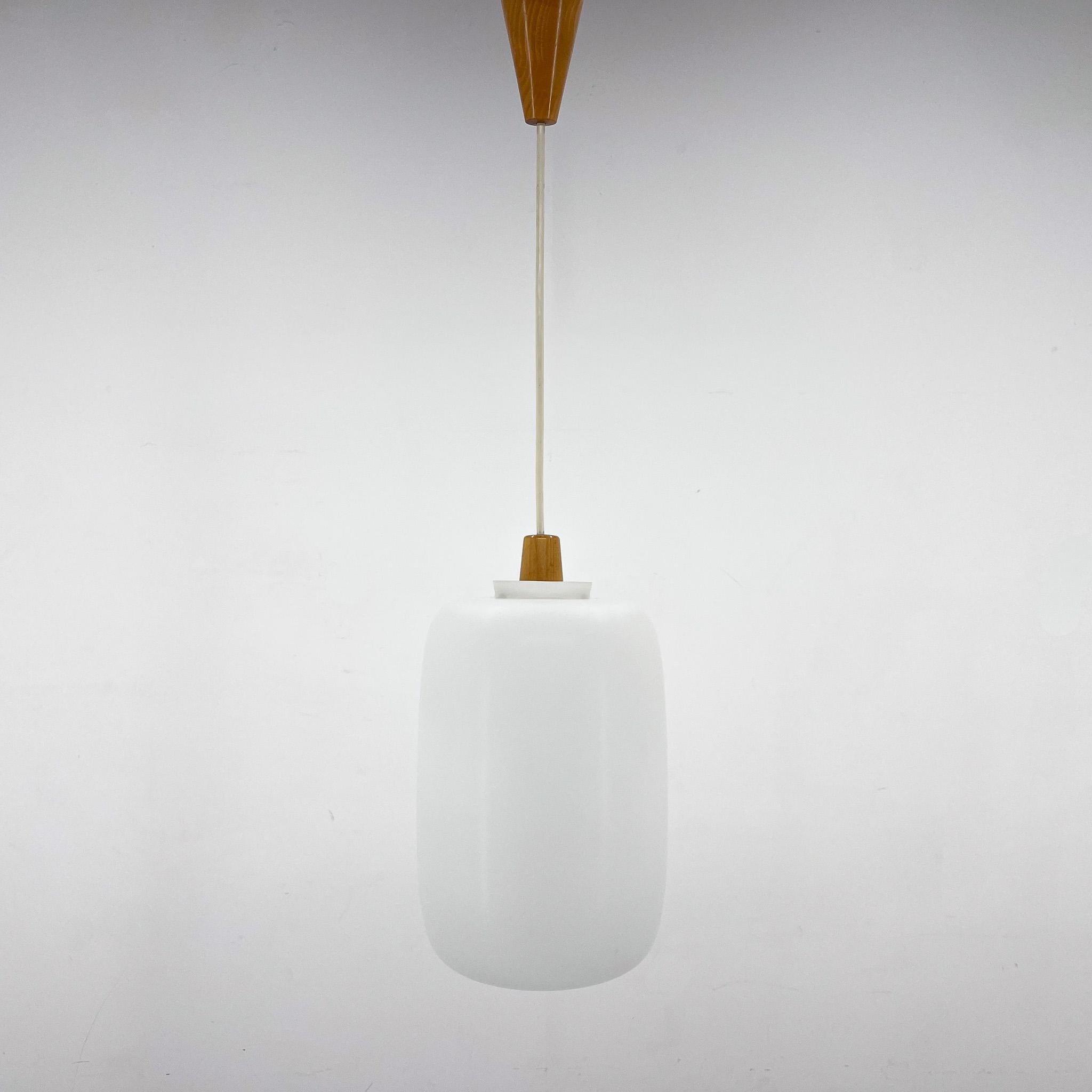Elegant midcentury pendant light by ULUV made from wood and milk glass. Produced in former Czechoslovakia in the 1960s. Good vintage condition. 
1x  E25-E27 sockets. US wiring compatible. 
