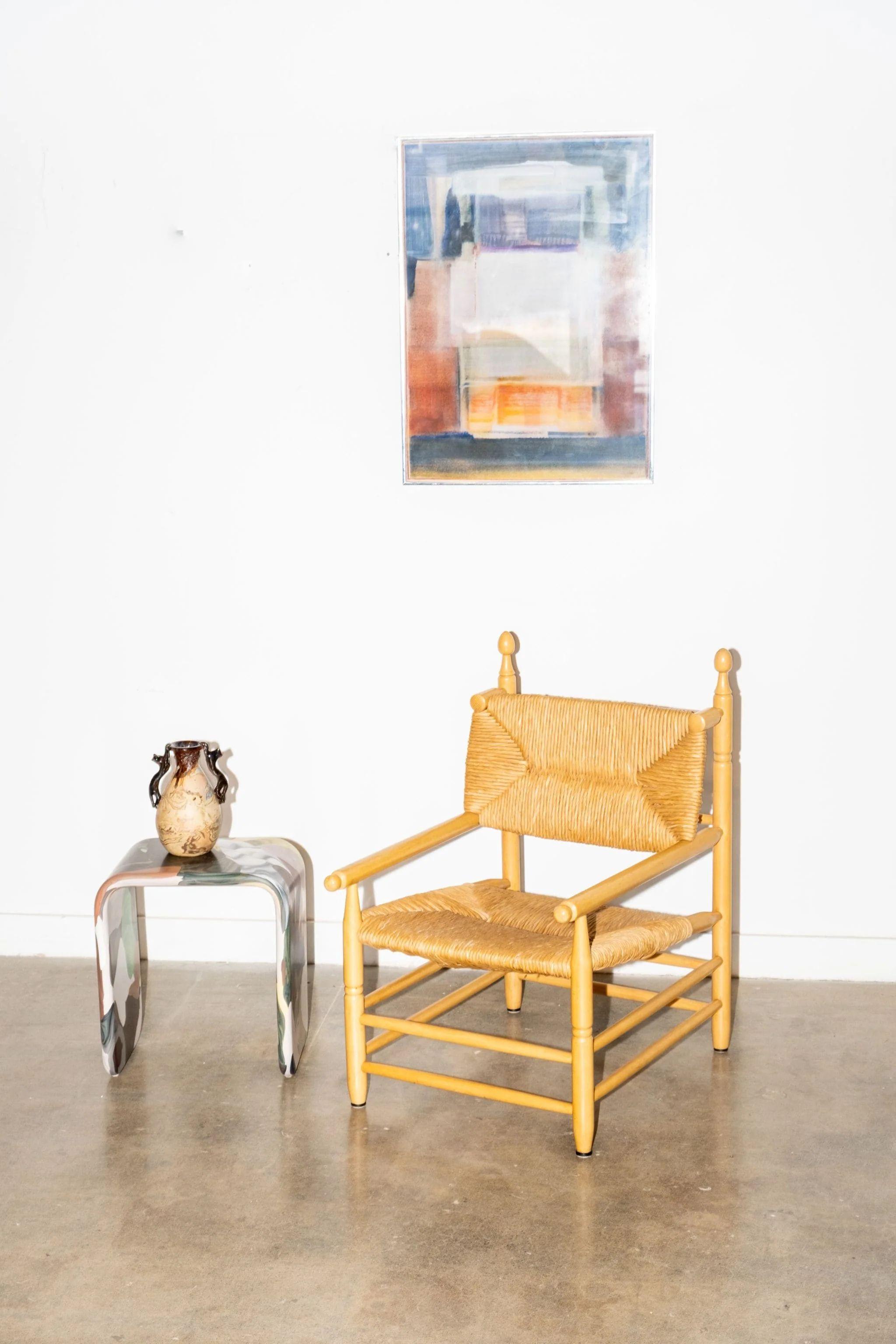 A single wood and rush seat armchair from 1960s coastal France. Rustic charm and elegant simplicity; an all in one. Excellent condition for its age. 