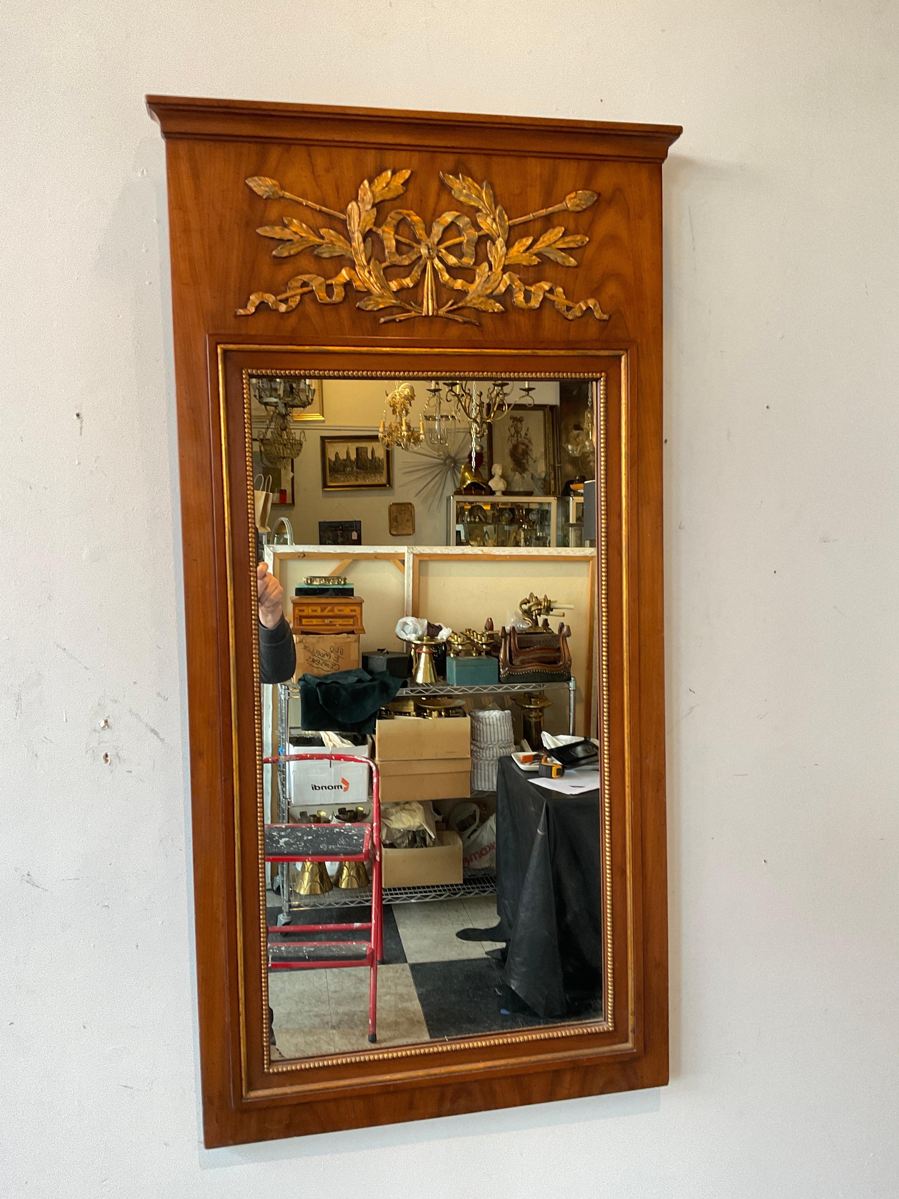 1960s Wood trumeau mirror with gold accents.