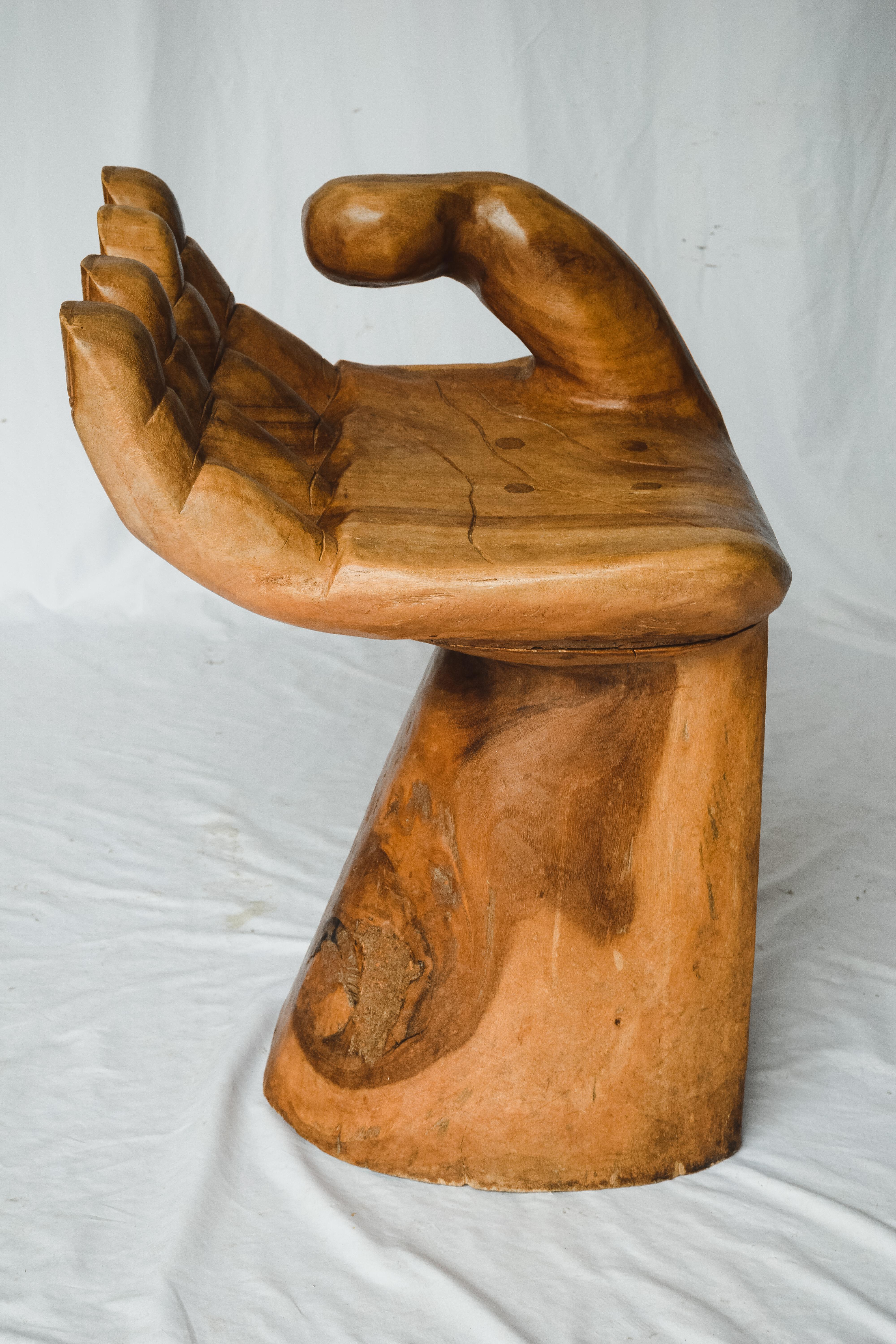 1960's wooden carved hand chair, or objet d'art after the iconic Pedro Friedeberg hand chair. This interesting piece would make a wonderful sculptural decoration, and/or conversation piece. Vintage 1960/ 1970's unsigned. This arm chair is solid and