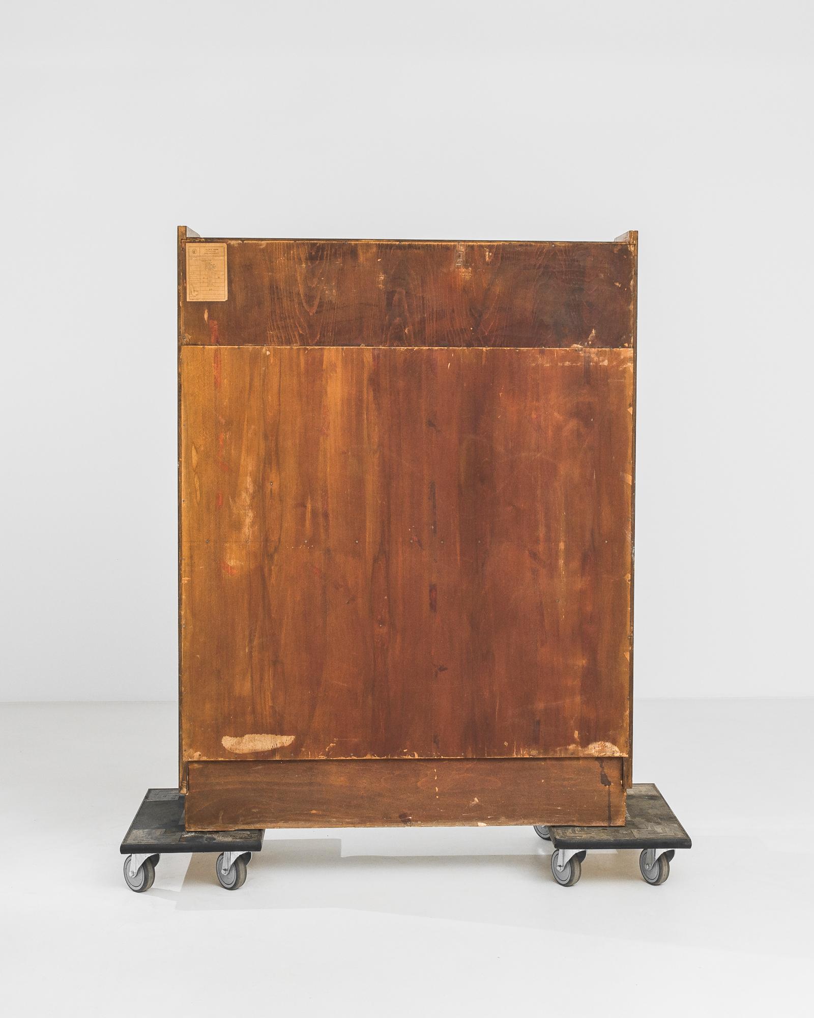 A wooden vitrine manufactured by Tatra Nabytok Pravenec in Czechia circa 1960. A sophisticated six shelf vitrine from one of the premier furniture manufacturers of the mid 20th Century. The angled front feet are mirrored by the slightly angled