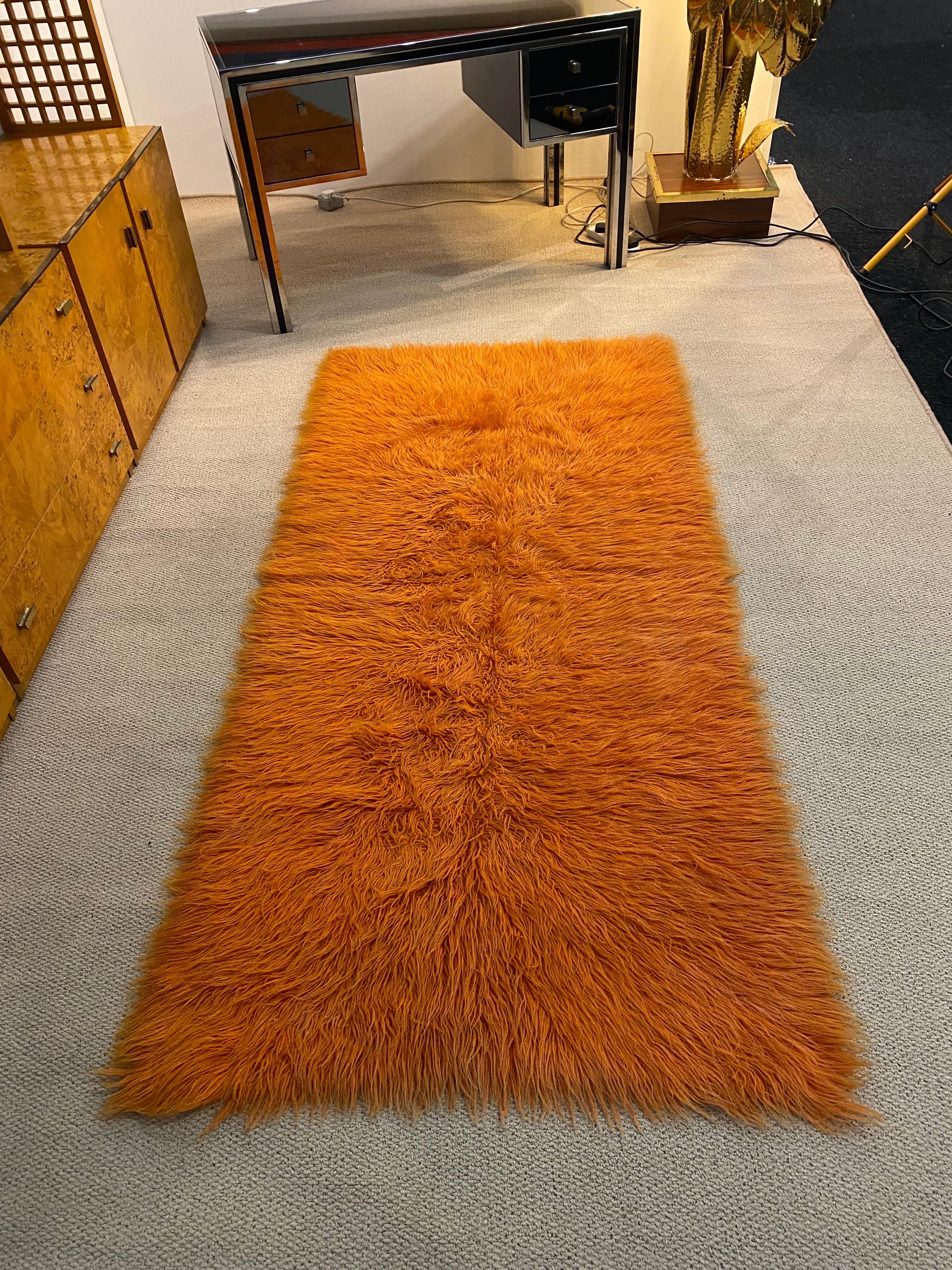 A beautiful and fluffy rug made in the 1950s as part of a girls dowry and passed on to the next generations. 
It is made out of pure wool, hand dyed naturally and weaved to give this fluffy effect. Its a piece of folk art, these pieces were used